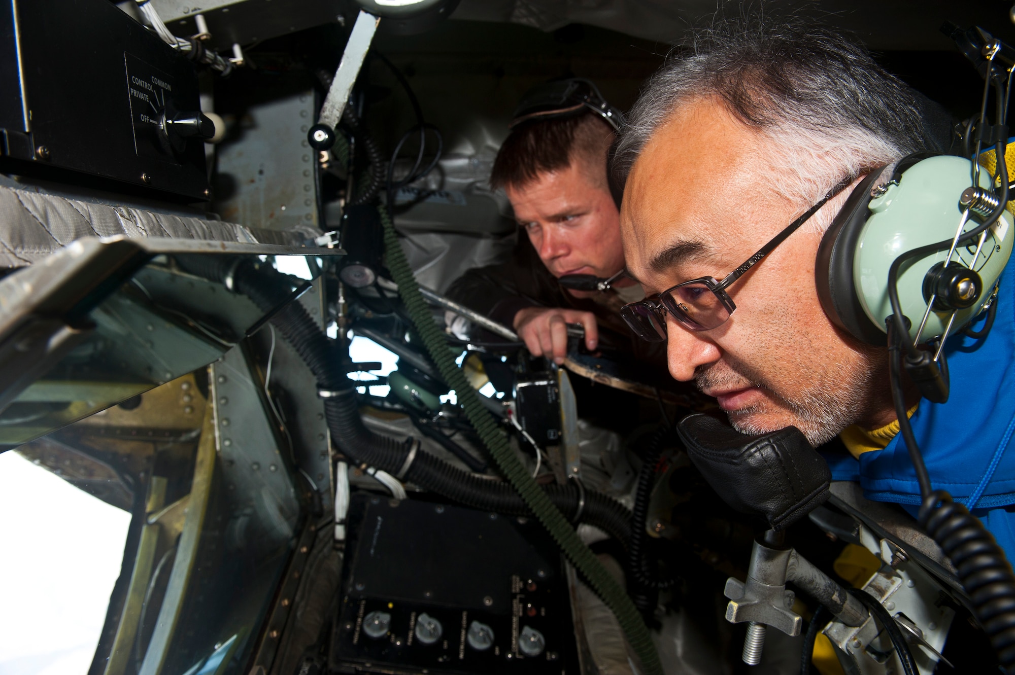 Right, Tursunbay Bakir Uulu observes out the back of a KC-135 Stratotanker as Master Sgt. Benjamin Cobb explains what a boom operator's responsibility is during an air refueling demonstration over Kyrgyzstan, Nov. 2, 2012. Members of the Kyrgyz Republic Parliament toured the Transit Center at Manas and experienced an air refueling capabilities demonstration. Cobb is a 22d Expeditionary Air Refueling Squadron boom operator deployed from MacDill Air Force Base, Fla. and Uulu is a member of the Kyrgyz Republic Parliament. (U.S. Air Force photo/Senior Airman Brett Clashman)