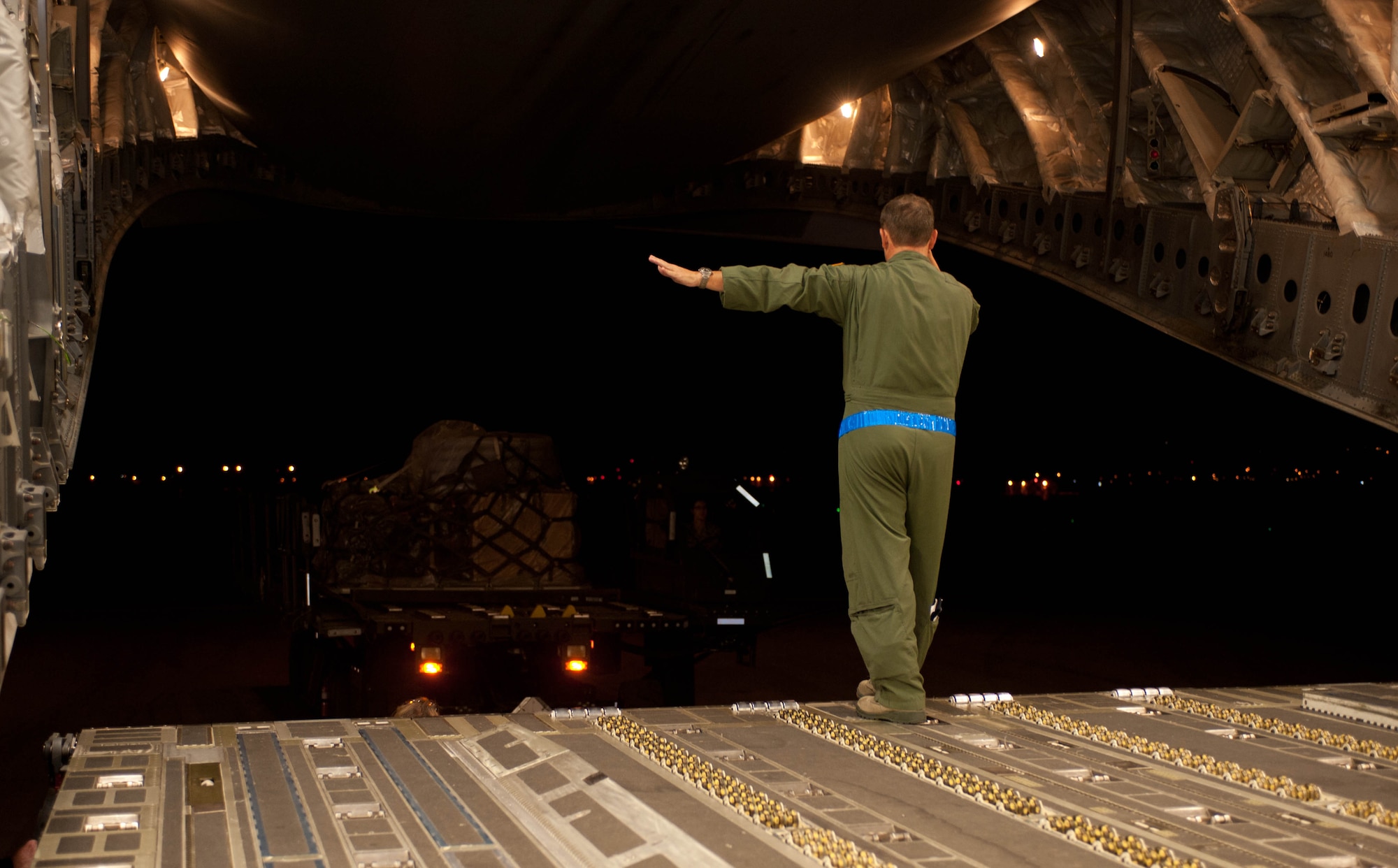 Master Sgt. Ron Dunn, 729th Airlift Support Squadron loadmaster, marshalls a load truck to unload equipment and supplies into a C-17 Globemaster at Ellsworth Air Force Base, S.D., Nov. 2, 2012. Working with the Federal Emergency Management Agency even before Hurricane Sandy hit, U.S. Air Force active duty, reserve and guard units began conducting round-the-clock operations to support relief efforts in New Jersey and New York. (U.S. Air Force photo by Airman 1st Class Zachary Hada/Released)