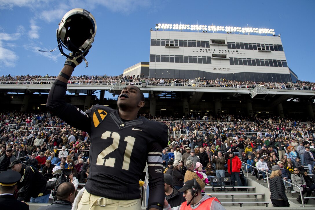 Waverly Washington of the Army Black Knights raises his helmet at the start of the Army-Air Force football game at the U.S. Military Academy at West Point, N.Y., Nov. 3, 2012. 