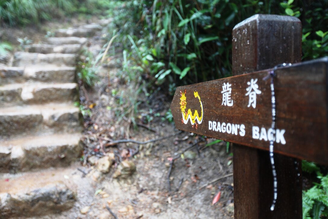 A wooden sign points the way to the entrance of the “Dragon’s Back,” a scenic trail taken by Marines and Sailors of the 31st Marine Expeditionary Unit and Sailors of the USS Bonhomme Richard (LHD-6) during a hike here, Oct. 30. Five local women hosted the event as part of the American Women’s Association’s Meals in the Home program, where local sponsors take in service members for a day of fun and a home-cooked meal. 
