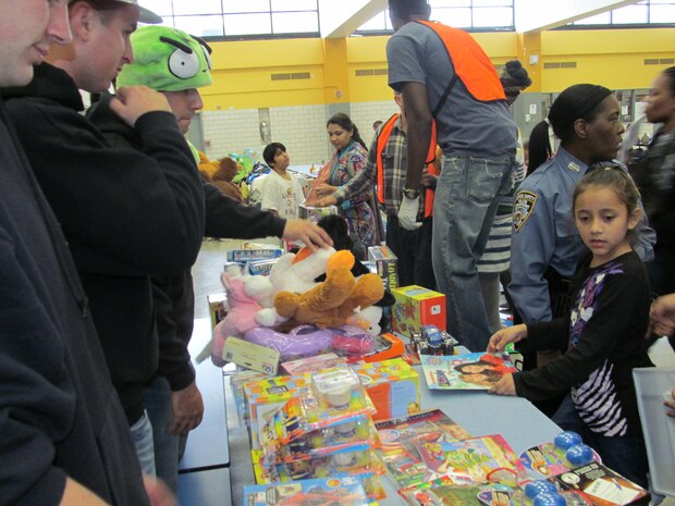 NEW YORK -- Marines from 6th Communications Battalion, in Brooklyn, N.Y., provided toys from Toys for Tots donations to children  displaced by Hurricane Sandy, Nov. 2, at Franklin Delano Roosevelt High School. Each year the Marines from 6th Communications Battalion receives hundreds of thousands of toy donations from New Yorkers. The Toys for Tots program helps less fortunate children throughout the United States experience the joy of Christmas. (Official Marine Corps courtesy photo / RELEASED)