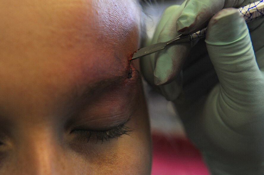 U.S. Air Force Airman 1st Class Bethony Smith, 18th Aerospace Medicine Squadron public health technician, has make-up applied to resemble a bruise and cut on her eyebrow for the Domestic Violence Awareness campaign on Kadena Air Base, Japan, Oct. 9, 2012. Smith kept the faux wound on all day as she did her daily routine in support of the "Thanks for asking" campaign. The two goals for the campaign are to enhance awareness of the available services for domestic violence and encourage people to speak up. (U.S. Air Force photo/Airman 1st Class Malia Jenkins)
