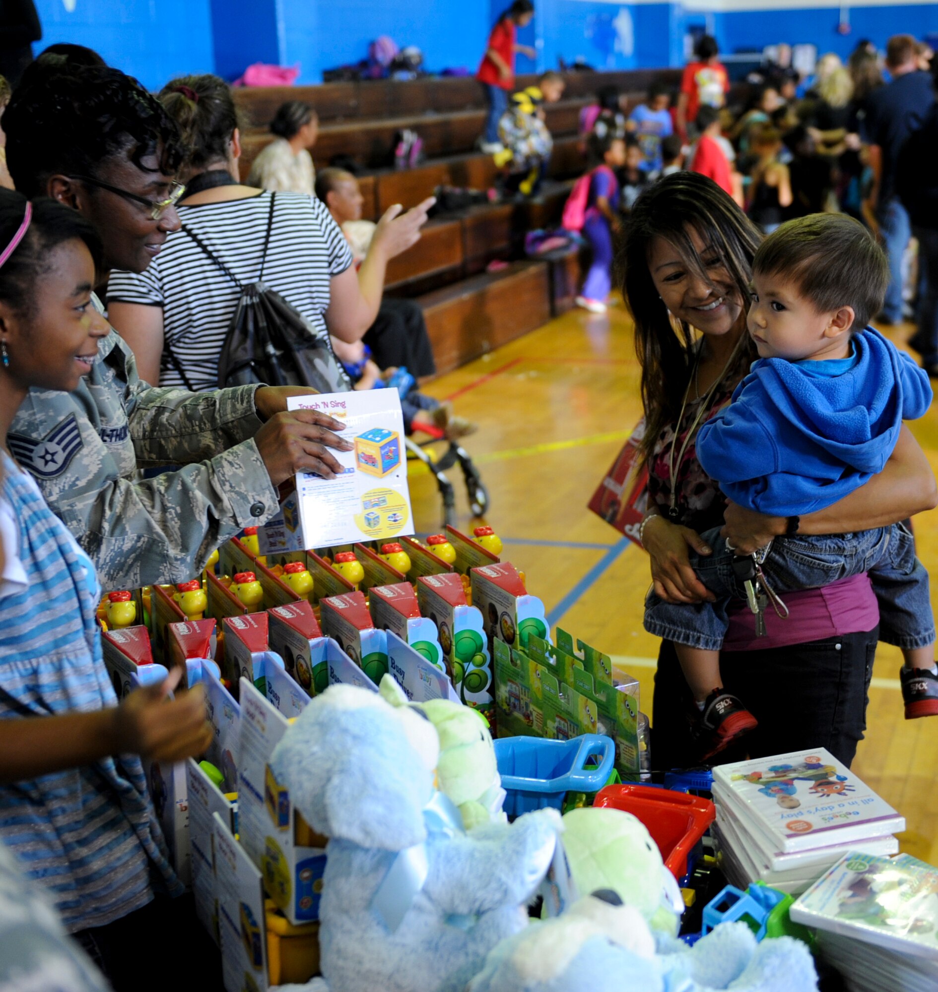 Kadena Airmen and volunteers pass out toys to children during the Play Comforts Toy Giveaway at the Kadena Teen Center on Kadena Air Base, Japan, Nov. 2, 2012. Play Comforts Toy Giveaway is an international event and it was the first year that Kadena was selected. Play Comforts, The Toy Industry Foundation and the Boys & Girls Club of America gave away 1,900 toys to children of military member and families who were stationed at Kadena. 
