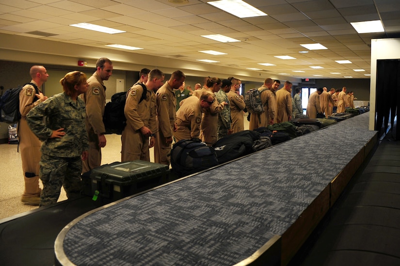 Members of the 17th Airlift Squadron collect their belongings in the passenger terminal after returning from a four-month deployment Nov. 4, 2012, at Joint Base Charleston – Air Base, S.C. While deployed, Airmen of the 17th AS served under the 816th Expeditionary Airlift Squadron and were responsible for airlift, airdrop and aeromedical evacuations, all of which directly support the combatant commander. (U.S. Air Force photo/ Airman 1st Class Chacarra Walker)