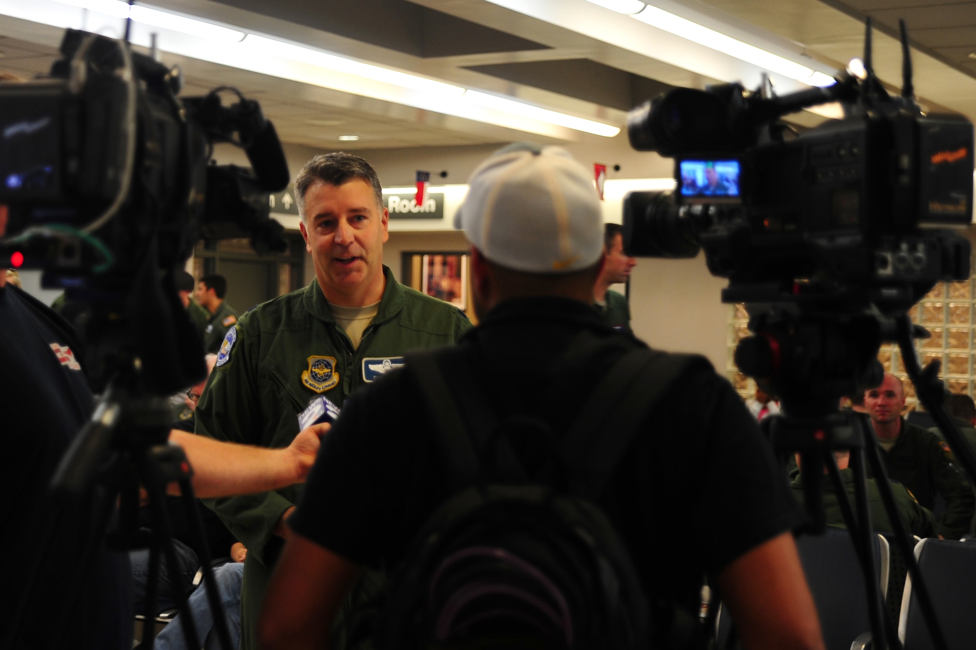 Lt. Col. Christopher Logan, 17th Airlift Squadron assistant director of operations, is interviewed by Channel 2 and Channel 5 while waiting for the return of the 17th AS, Nov. 4, 2012, at Joint Base Charleston - Air Base, S.C. While deployed, the 17th AS supported roughly 2,467 sorties, logged more than 5,600 combat flying hours and airlifted more than 105 million pounds of cargo and more than 14,000 personnel throughout Southwest Asia. (U.S. Air Force photo/ Airman 1st Class Chacarra Walker)