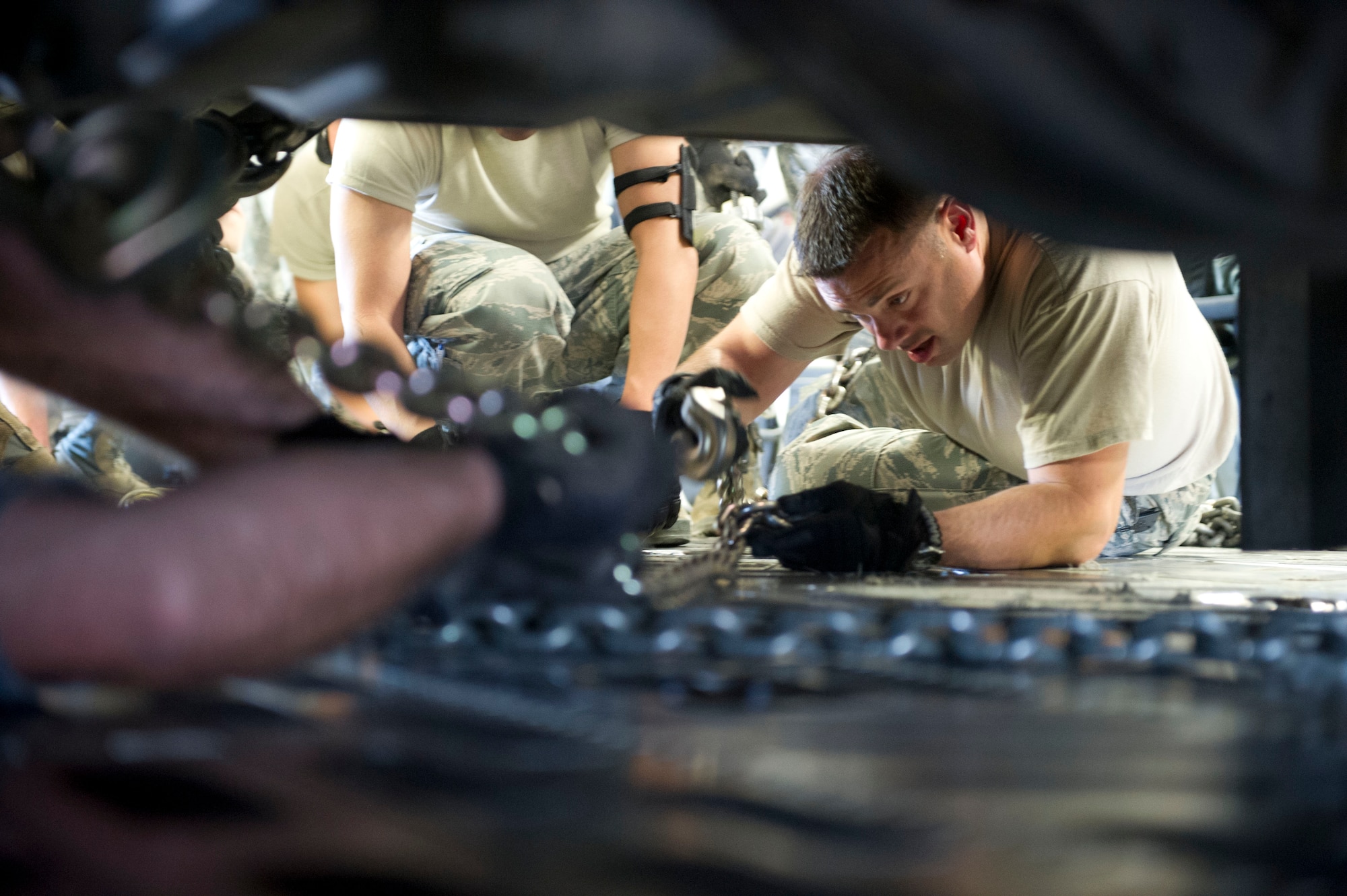 Airman from the 621st Contingency Response Wing, Travis Air Force Base, Calif. and the Arizona Air National Guard, work together to secure a vehicle in an Air Force C-17 Globemaster III at the Sky Harbor Air National Guard Base in Phoenix, Ariz., bound for N.Y. to support the Hurricane Sandy relief efforts, November 3, 2012. The 621st CRW is highly-specialized in training and rapidly deploying personnel to quickly open airfields and establish, expand, sustain, and coordinate air mobility operations. (U.S. Air Force photo by Staff Sgt. Gustavo Gonzalez) 