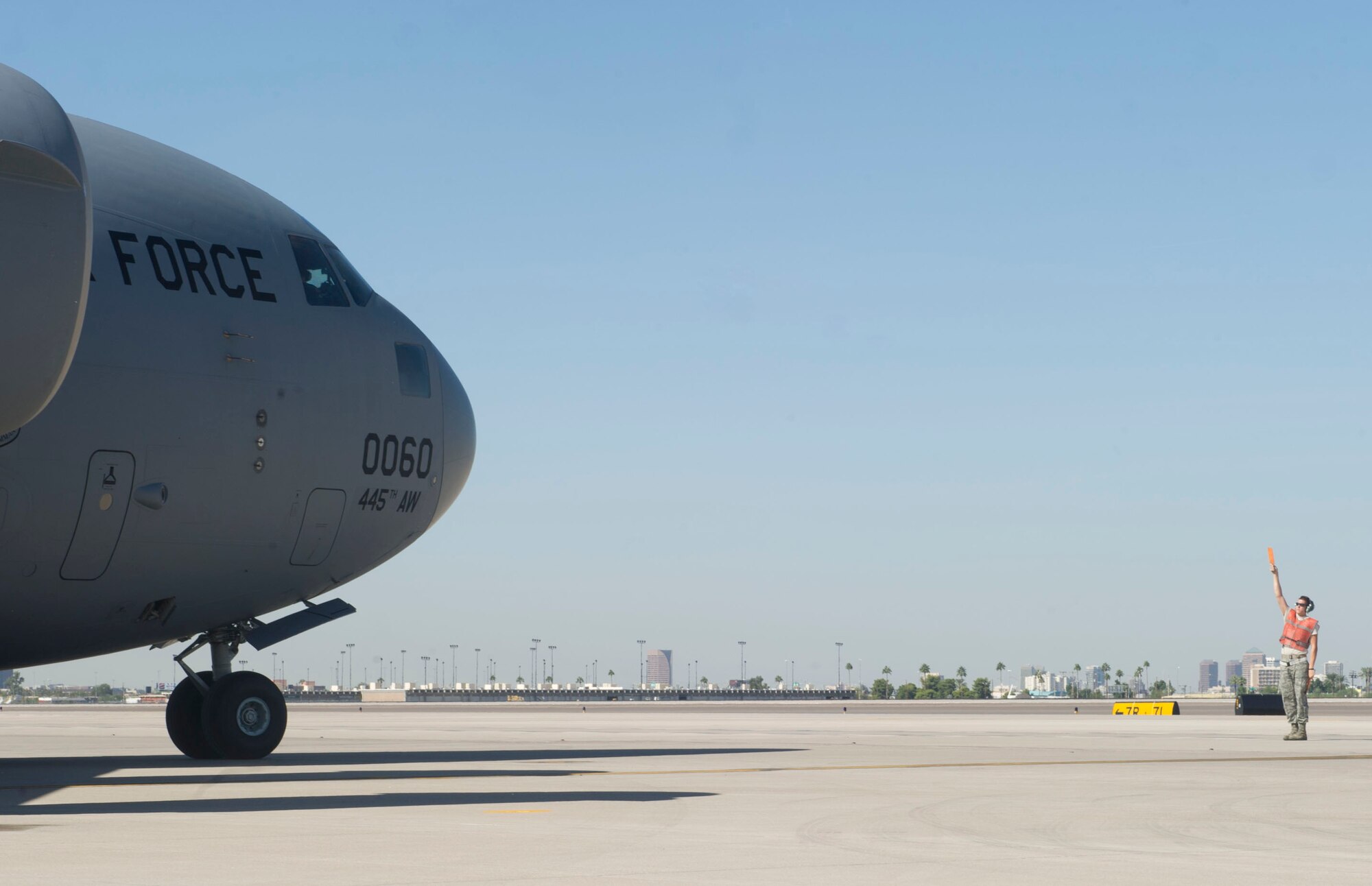 An Airman from the 621st Contingency Response Wing, Travis Air Force Base, Calif., marshals an Air Force C-17 Globemaster III at the Sky Harbor Air National Guard Base in Phoenix, Ariz., bound for N.Y. to support the Hurricane Sandy relief efforts, November 3, 2012. The 621st CRW is highly-specialized in training and rapidly deploying personnel to quickly open airfields and establish, expand, sustain, and coordinate air mobility operations. (U.S. Air Force photo by Staff Sgt. Gustavo Gonzalez)