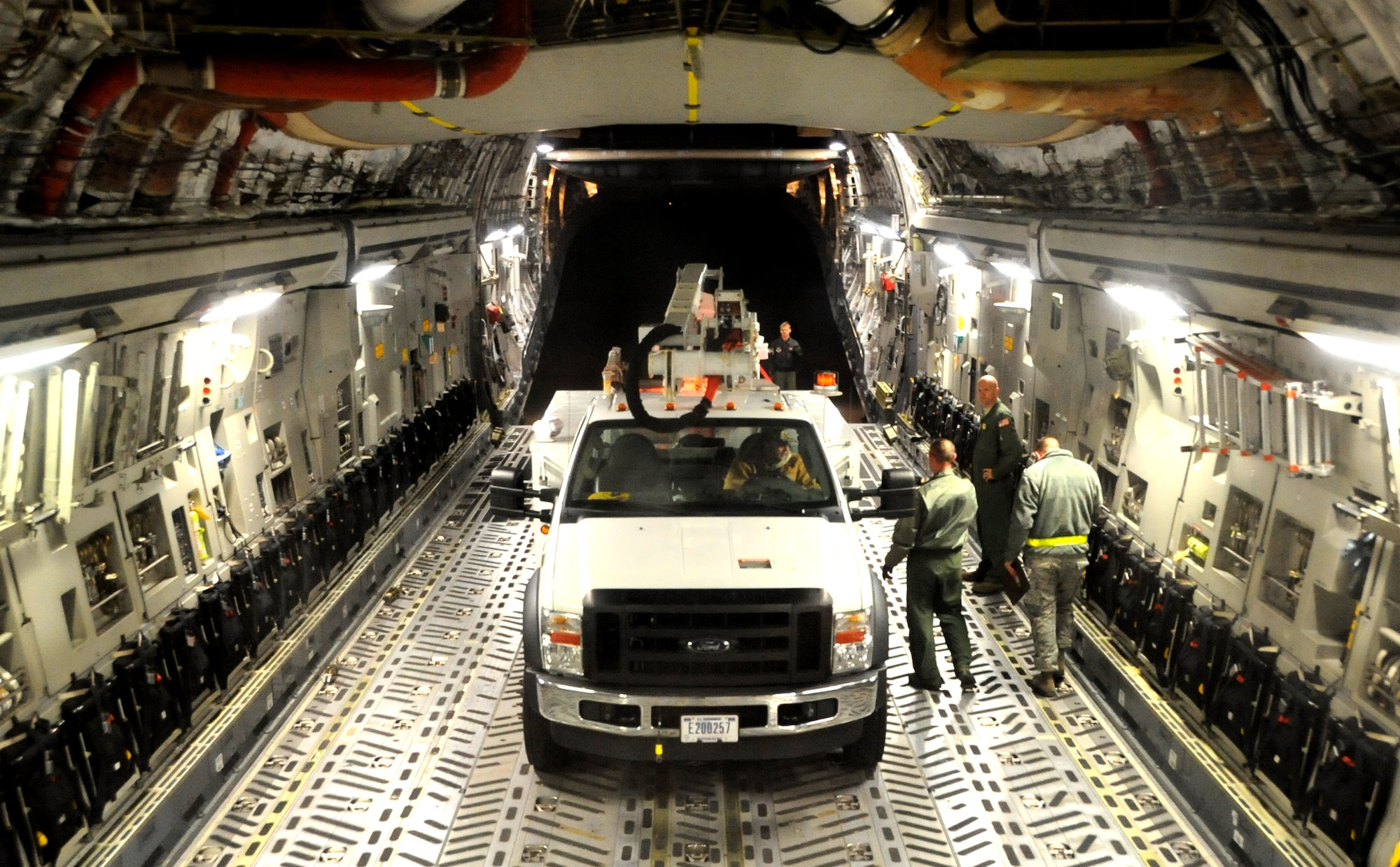 JOINT BASE MCGUIRE-DIX-LAKEHURST, N.J. -- Airmen from the 437th Airlift Wing, 16th Airlift Squadron, out of Joint Base Charleston, S.C., flew Hurricane Sandy relief supplies on a C-17 Globemaster III from Fairchild Air Force Base, Wash., to Joint Base McGuire-Dix-Lakehurst, N.J., Nov. 3, 2012. The supplies included two line trucks, a bucket truck and a set of mobile flood lights which will be used to support relief efforts in Staten Island and Long Island, N.Y. (U.S. Air Force photo by 2nd Lt. David J. Murphy/Released)
