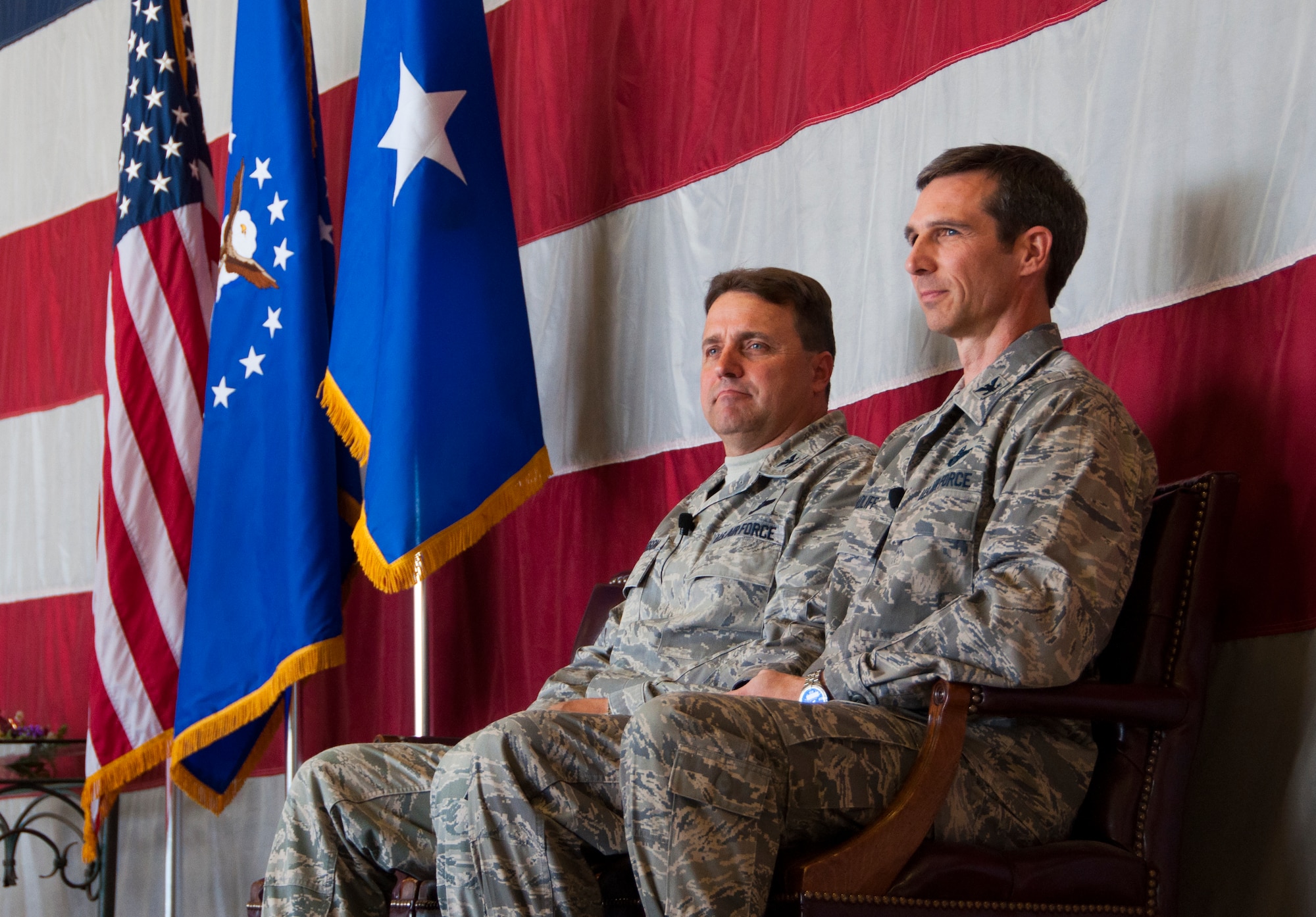 Col. Bryan Radliff, 419th Fighter Wing commander, and his predecessor, Col. Keith Knudson, sit on stage during the change of command ceremony here today. (U.S. Air Force photo/Senior Airman Crystal Charriere)