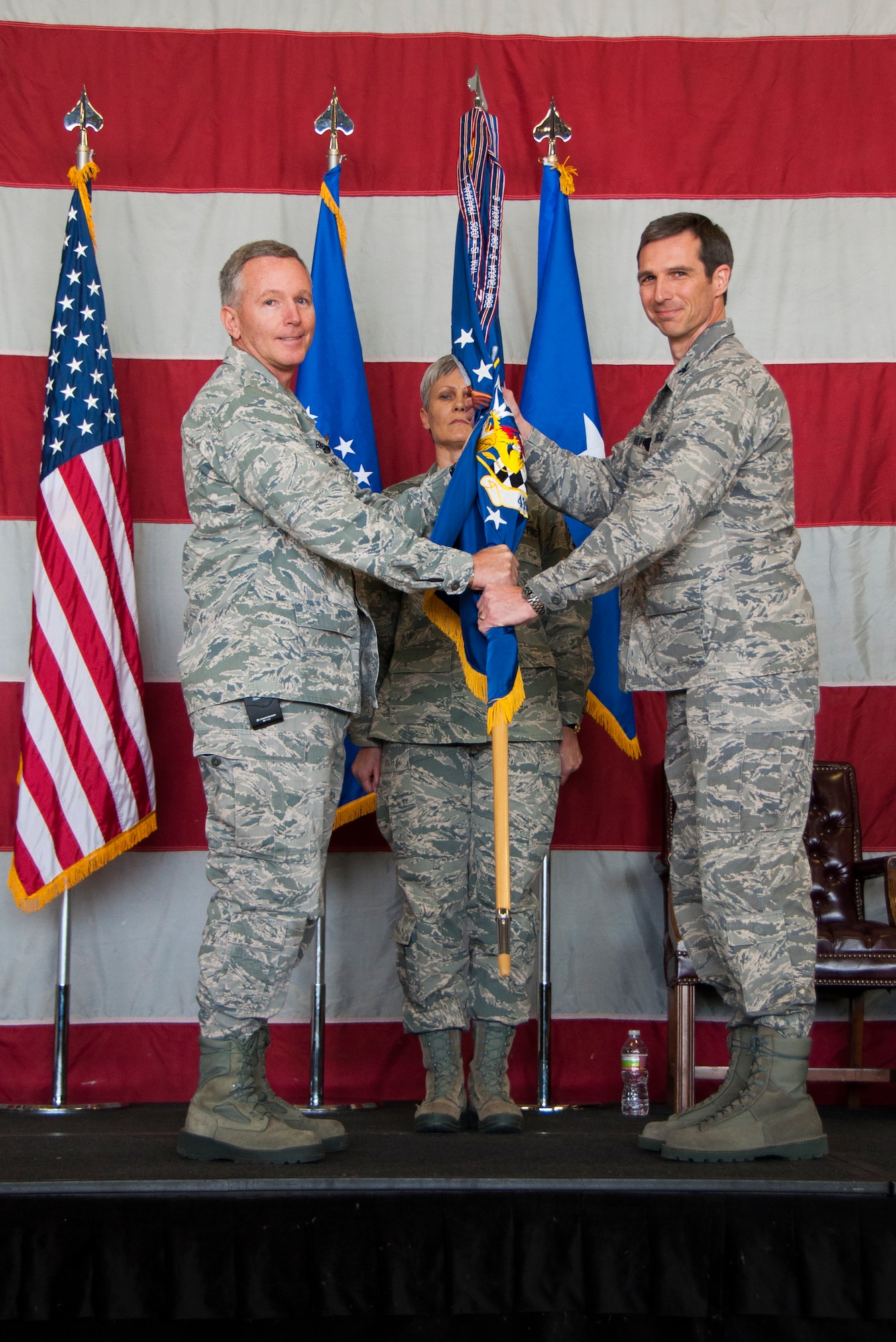 10th Air Force Commander, Brig. Gen. William Binger, passes the 419th Fighter Wing flag to Col. Bryan Radliff during a change of command ceremony here today. (U.S. Air Force photo/Senior Airman Crystal Charriere)