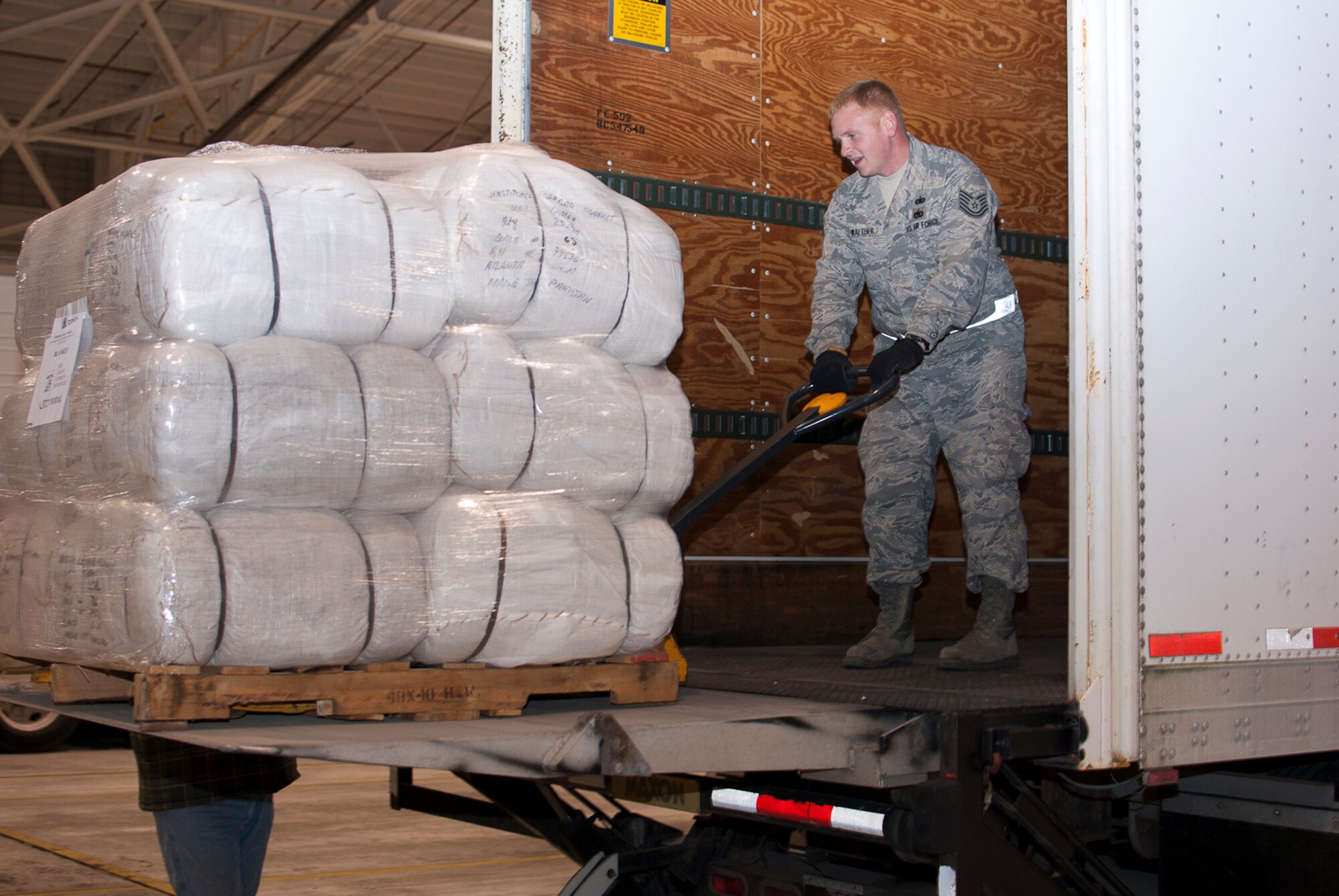 Tech. Sgt. Justin Walther manuevers a pallet of blankets provided by FEMA, Nov. 3, 2012, at the 167th Airlift Wing, Martinsburg, W.Va. FEMA delivered 25,000 blankets to the unit. The blankets were transported to New York via C-130 aircrafts from Little Rock, Ark. (Air National Guard photo by 2nd Lt. Stacy Gault)