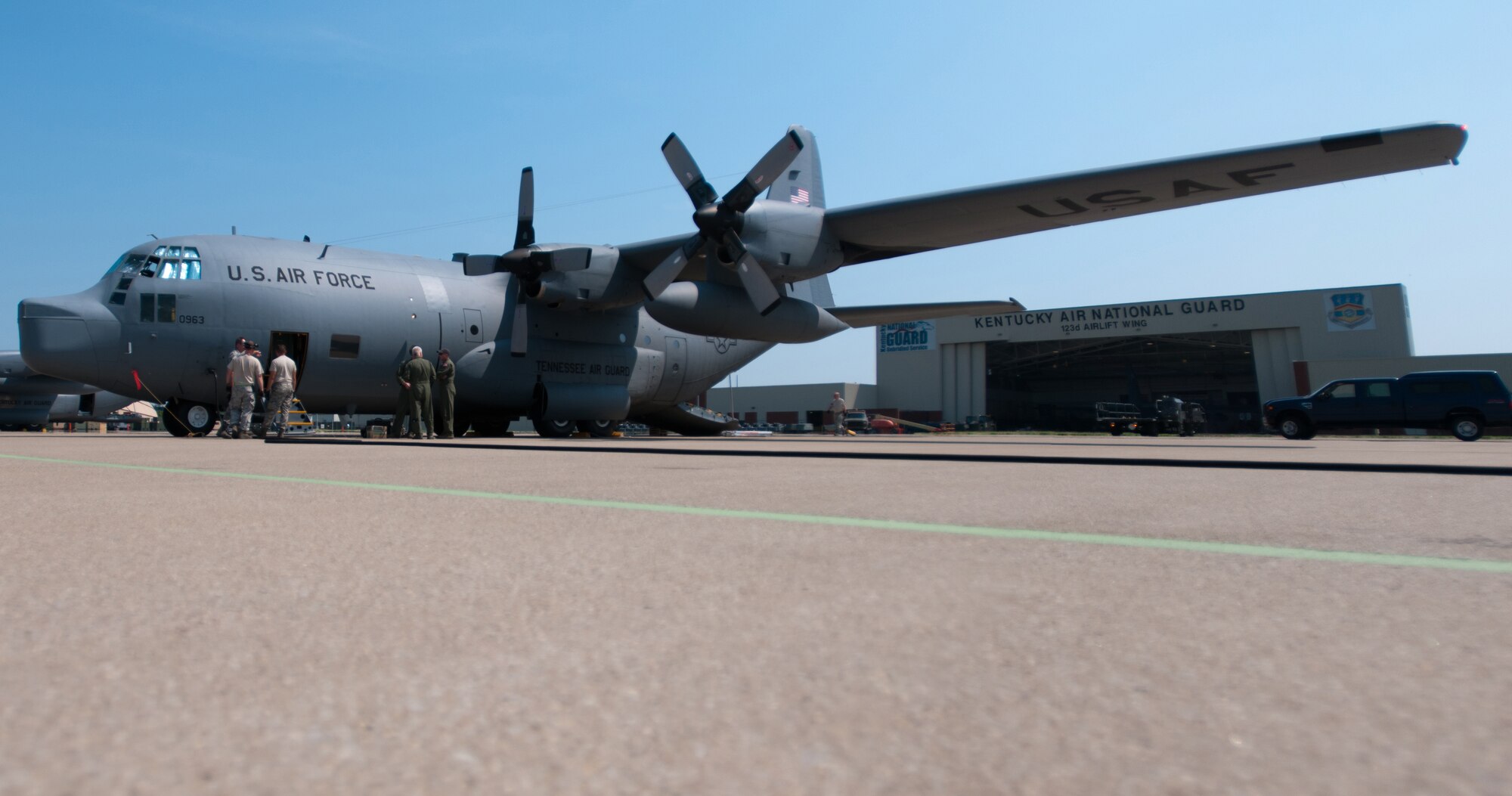 Aircrew members and aircraft maintenance personnel inspect a former Tennessee Air Guard C-130 on the flight line of the Kentucky Air National Guard Base in Louisville, Ky., on July 25, 2012. The plane was transferred to Kentucky following a mission realignment at the Nashville-based 118th Airlift Wing. (U.S. Air Force photo by Master Sgt. Phil Speck)