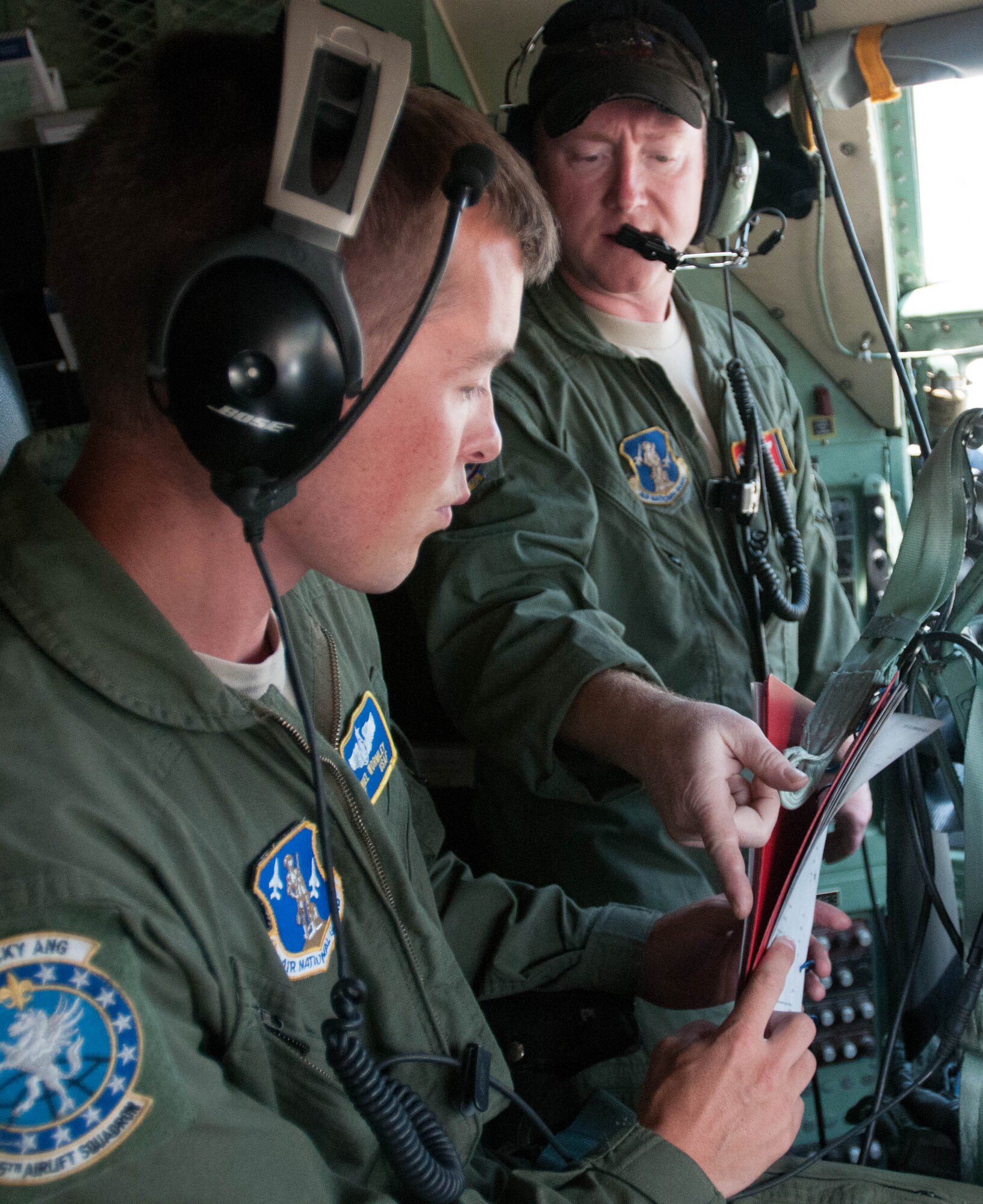 Tennessee Air National Guard Master Sgt. Roy Roberts, a flight engineer for the 118th Airlift Wing, points out some differences in the configuration of a C-130 Hercules ???Super E" aircraft to Kentucky Air National Guard Staff Sgt. Daniel Wormley, a flight engineer for the 165th Airlift Squadron, at the Kentucky Air National Guard Base in Louisville, Ky., on July 26, 2012.  The Kentucky Air National Guard, which already flies the C-130 ???H??? model, acquired the older Super E aircraft from the Tennessee Air National Guard. (Kentucky Air National Guard photo by Master Sgt. Phil Speck)