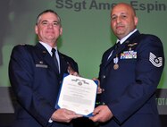 Air Force Reserve Col. Jay Pittman, 302nd Airlift Wing commander, presents the Air Force Achievement Medal to Tech. Sgt. Ibrahim Farah Nov. 4 during a wing commander's call at Peterson Air Force Base, Colo. Farah, assigned to the 34th Aeromedical Evacuation Squadron, earned the medal for several actions performed, including his involvement in evaluating the C-27 Spartan transport aircraft for medical evacuation potential. (U.S. Air Force photo/Staff Sgt. Stephen J. Collier)