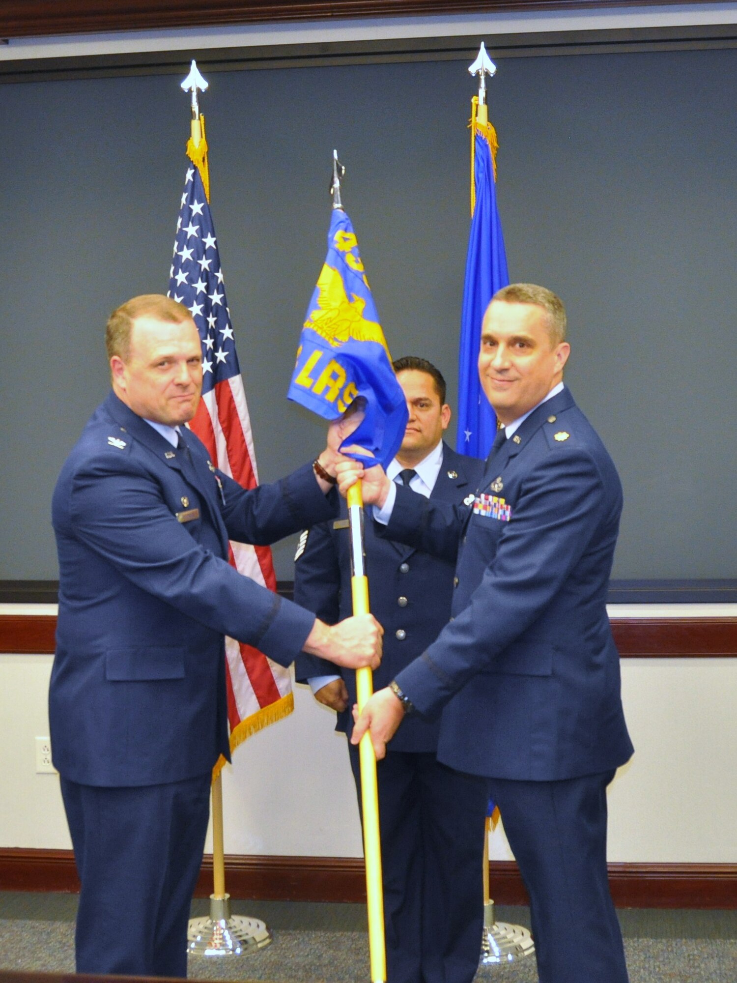 Maj. James Hearn (right) takes the guidon of the 433rd Logistics Readiness Squadron from Col. Craig Petersen, 433rd MIssion Support Group commander, during an assumption of command ceremony at Joint Base San Antonio - Lackland Nov. 4. He previously served as the operations officer with the unit.  "It's my job to provide you the resources and training you need to accomplish your mission. The LRS is a critical cog in the 433rd Airlift Wing machine. We will be semper paratus, always prepared," he said. (U.S. Air Force photo/Tech Sgt. Carlos J. Trevino)