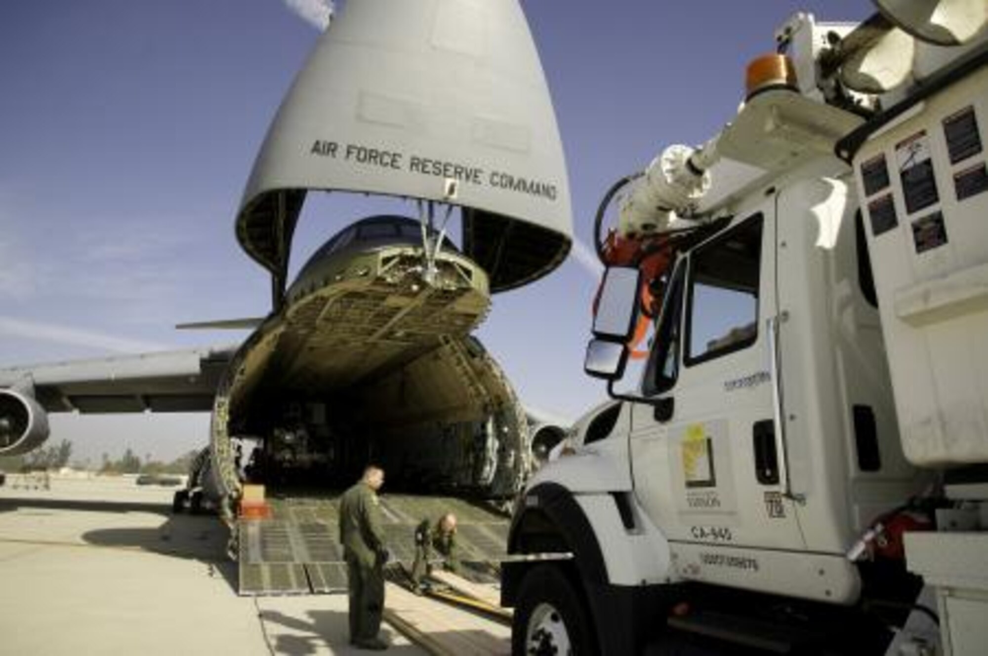 A Southern California Edison truck is loaded onto a U.S. Air Force C-5
Galaxy aircraft in support of Hurricane Sandy relief efforts at March Air
Reserve Base, Calif., Nov. 1, 2012. Military bases across the nation are
mobilizing to the northeast region of the country to restore electricity and
provide humanitarian assistance, as currently more than two million people
are without power. (U.S. Air Force file photo)
