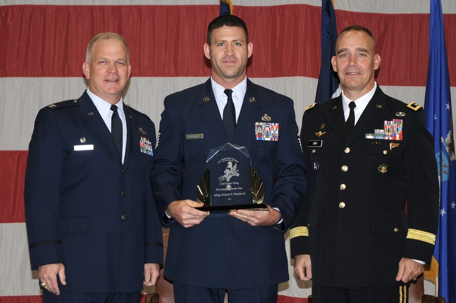 Maj. Gen. Timothy Orr (right), Adjutant General of the IA National Guard, and Col. Drew DeHaes (left), 132nd Fighter Wing (132FW) Commander, present Master Sgt. Bobby Shepherd (middle) with the First Sergeant of the Year award during the 2012 Annual Awards Ceremony held in the hangar of the 132FW, Des Moines, Iowa on November 3, 2012.  (US Air Force photo/Staff Sgt. Linda K. Burger)(Released)