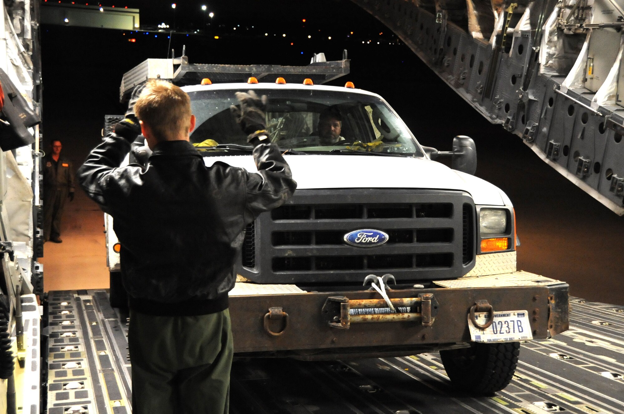 JOINT BASE MCGUIRE-DIX-LAKEHURST, N.J. -- Staff Sgt. Tim Jaskot, 437th Airlift Wing loadmaster, Joint Base Charleston, S.C., works with Kurk Shriver, Bonneville Power Administration lineman, to get a work truck off of a C-17 Globemaster III here Nov. 3, 2012. The supplies included two line trucks, a bucket truck and a set of mobile flood lights, which will be used to support relief efforts in Staten Island and Long Island, N.Y. A total-force team of active-duty, Guard and Reserve Airmen continue to work side-by-side with federal, state and local mission partners to assist in the Northeast region's recovery from Hurricane Sandy.  (U.S. Air Force photo by 2nd Lt. David J. Murphy/Released)
