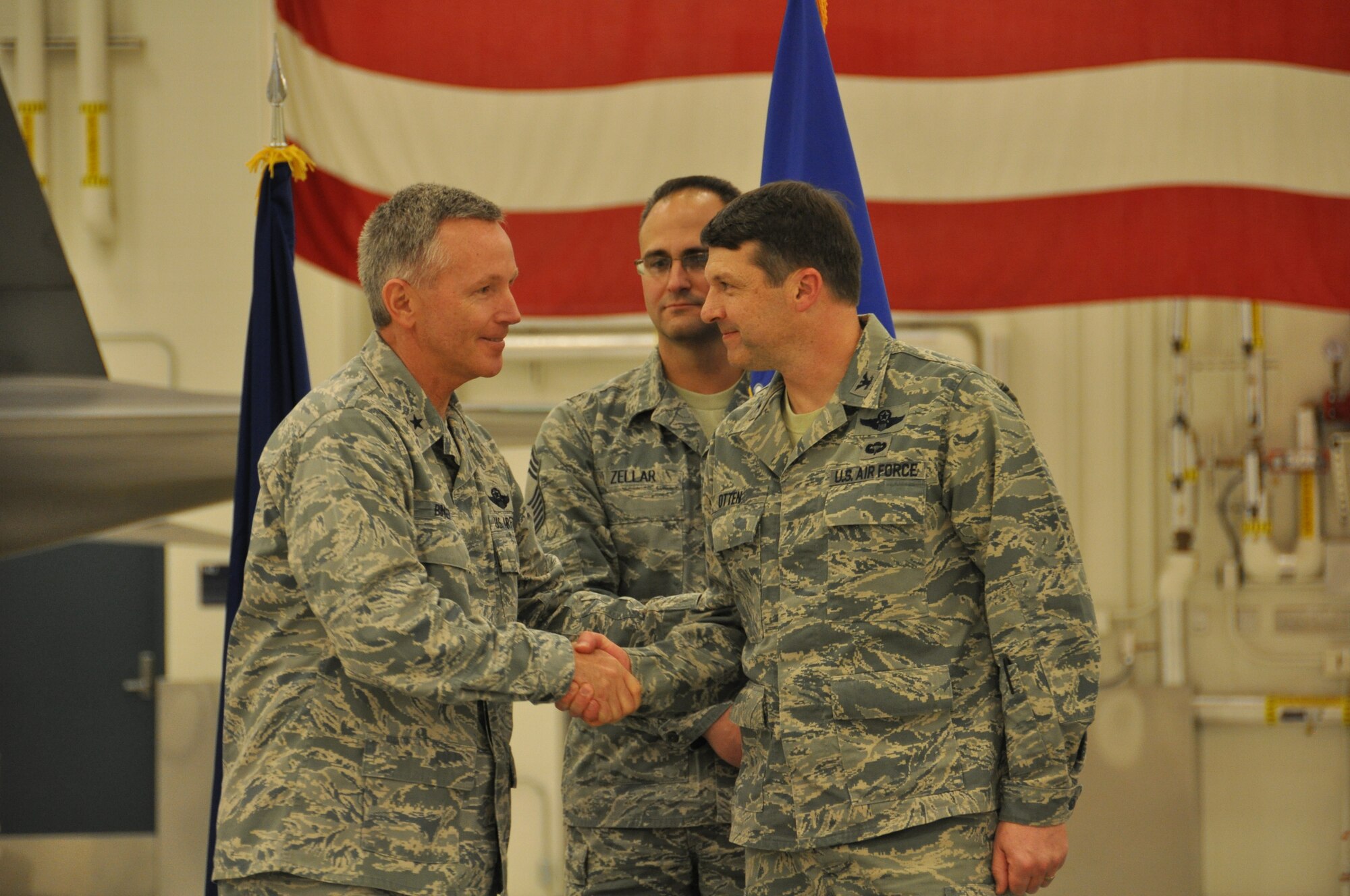 Brig. Gen. William Binger, 10th Air Force commander, congratulates Col. Tyler Otten on his new role as the 477th Fighter Group commander. Otten took command from Col. Bryan Radliff during a ceremony here Nov. 2. (U.S. Air Force Reserve/Tech. Sgt. Dana Rosso) 