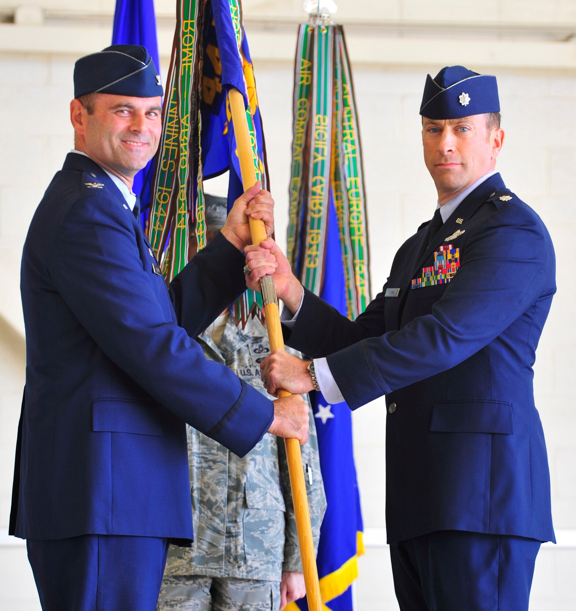 HOLLOMAN AIR FORCE BASE, N.M. -- Col. Kent Furman hands the ceremonial flag to Lt. Col. Andrew Lyons during an assumption of command ceremony here Nov. 3.  (U.S. Air Force photo by Senior Airman Martha Whipple/Released)