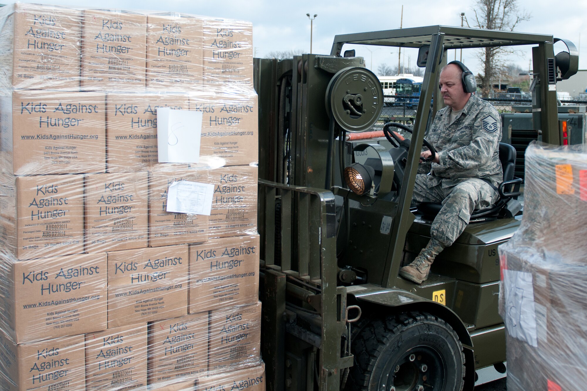 Master Sgt. Robert Brown, traffic manager for the 123rd Logistics Readiness Squadron, moves pallets of food destined for Haiti in preparation for loading them onto U.S. Air Force planes March 13, 2012. The Kentucky Air National Guard is helping Children???s Lifeline, a Kentucky-based non-profit organization, ship food and other supplies to Haiti through the Denton Program. The Denton Program is a U.S. government effort that allows private citizens and organizations to use space available on U.S. military cargo planes to transport humanitarian goods. (U.S. Air Force photo by Master Sgt. Phil Speck)