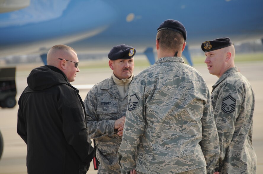 Chief Master Sgt. Michael Stewart, Master Sgt. Robert Combs and Senior Master Sgt. Ryan Hart talk with a secret service member while guarding the president's aircraft while it awaits his arrival at the 178th Figther Wing, Springfield, Ohio Nov. 1. Cleared for public release by Senior Master Sgt. Joseph Stahl.