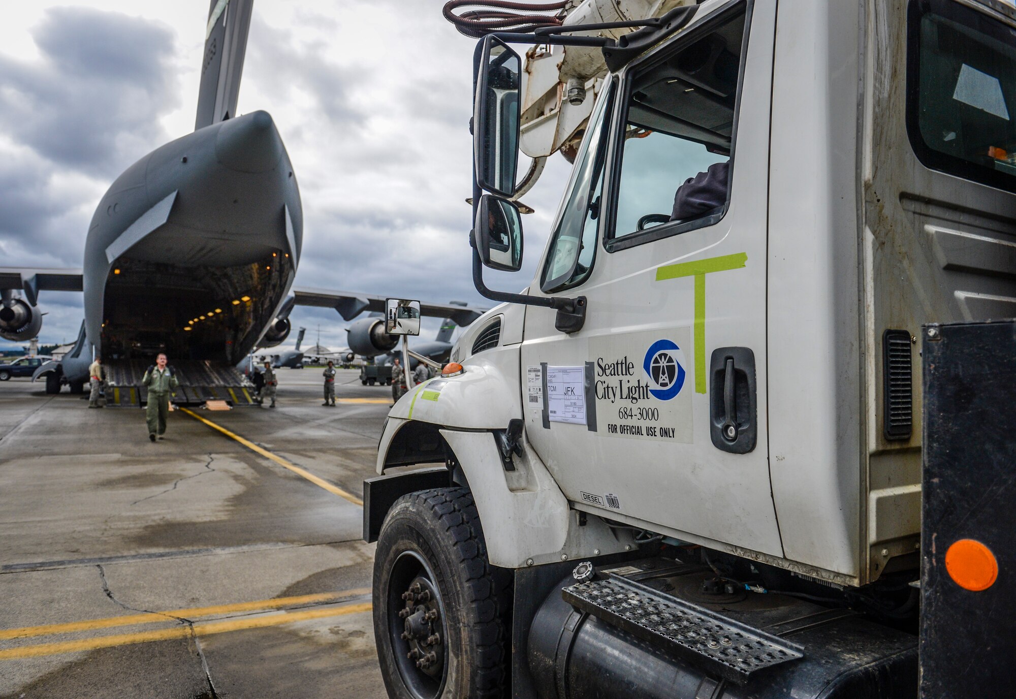 A Seattle City Light utility truck is guided onto a C-17 Globemaster III aircraft, Nov. 3, 2012, at Joint Base Lewis-McChord, Wash. The truck was transported to New York City to aid in the Hurricane Sandy relief effort. (U.S. Air Force photo/Staff Sgt. Sean Tobin)