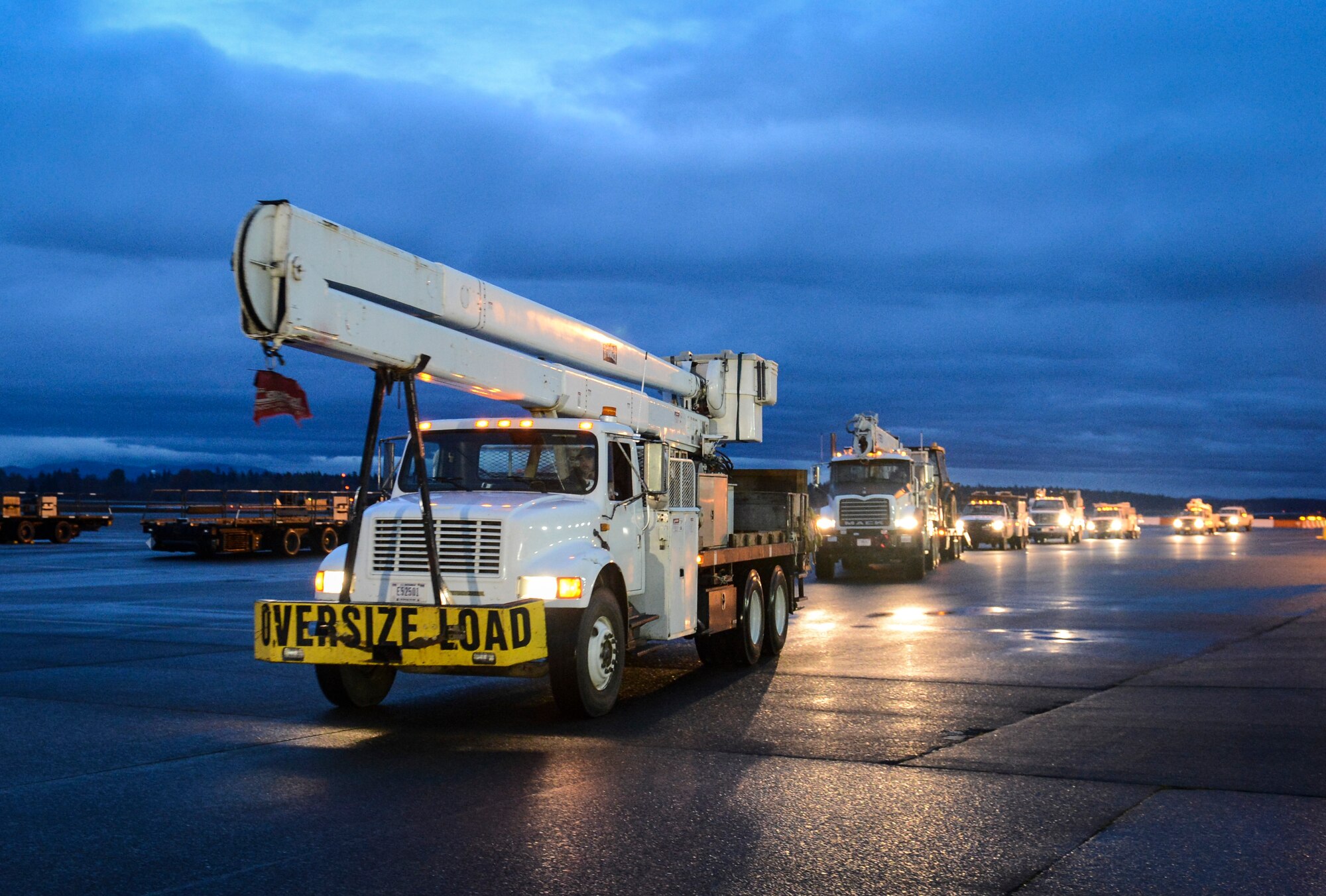 A convoy of utility vehicles from Bonneville Power Administration in Olympia, Wash., arrives early morning Nov. 3, 2012, at Joint Base Lewis-McChord, Wash. The vehicles, slated to be airlifted to New Jersey for Hurricane Sandy relief efforts, must all be washed, weighed, measured and secured prior to being loaded onto a U.S. Air Force aircraft. (U.S. Air Force photo/Staff Sgt. Sean Tobin)