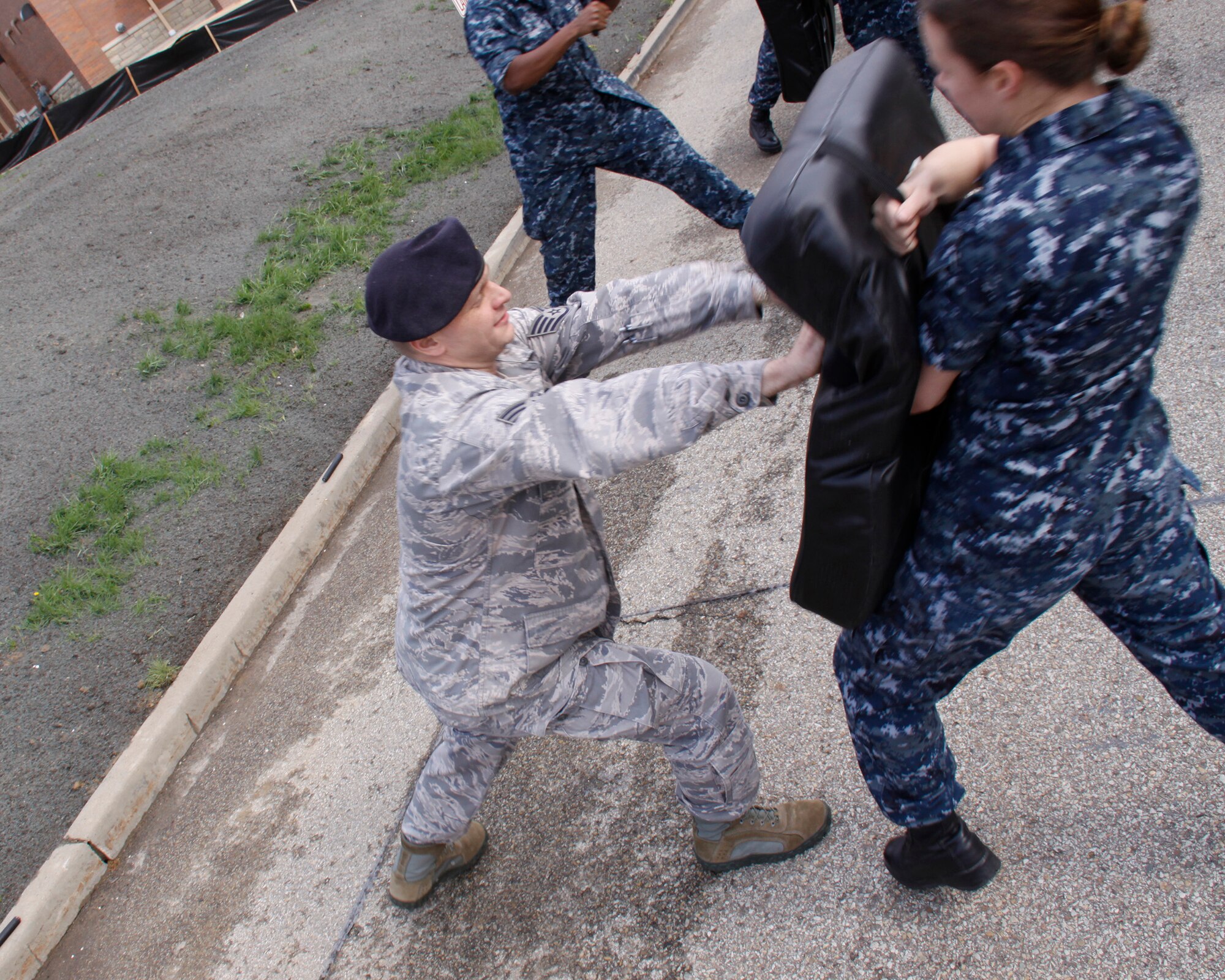 Staff Sgt. Jason Sullivan, Security Forces Squadron Patrolman, 911th Airlift Wing, participates in a joint combative training with Pittsburgh Naval Security Forces at the 911th AW, Pittsburgh, Pa., April 15, 2012. Sullivan, along with the Navy, is learning to use a baton to force an oppressor backwards. (U.S. Air Force photo by Airman 1st Class Justyne Obeldobel/Released)