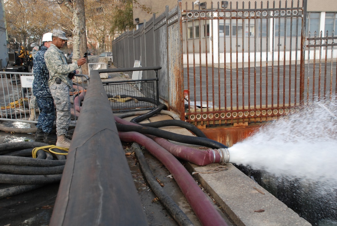 Lt. Gen. Thomas P. Bostick, U.S. Army Chief of Engineers and Commanding General of the U.S. Army Corps of Engineers, photographs the Corps' dewatering operation Nov 3 in lower Manhattan. (U.S. Army photo by Mary Markos)
