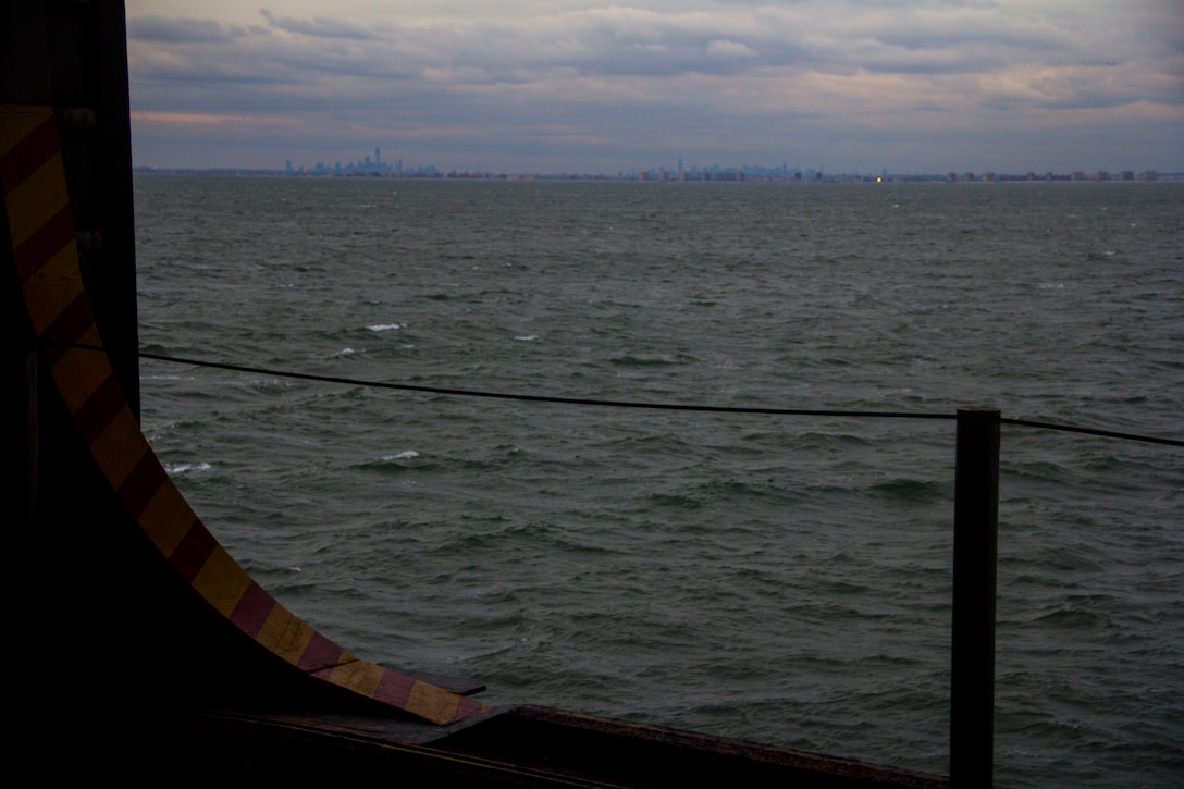New York City is visible from the deck of USS Wasp, where Marines and sailors of the 26th Marine Expeditionary Unit embarked aboard, Nov. 1, 2012, to assist in disaster relief efforts in the aftermath of Hurricane Sandy. The 26th MEU is able to provide generators, fuel, clean water, and helicopter lift capabilities to aid in disaster relief efforts. The 26th MEU is currently conducting pre-deployment training, preparing for their departure in 2013. As an expeditionary crisis response force operating from the sea the MEU is a Marine Air-Ground Task Force capable of conducting amphibious operations, crisis response, and limited contingency operations. (U.S. Marine Corps photo by Cpl. Michael S. Lockett/Released)