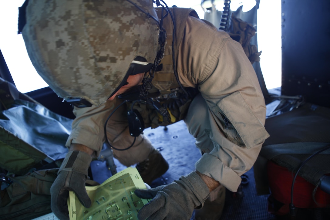 Sgt. Travis P. Trahan, a UH-1N Huey crew chief with Detachment A, Marine Light Attack Helicopter Squadron 773, Marine Aircraft Group 49, checks his map during a simulated close air support mission at Fort Irwin, Calif., October 17, 2012.  HMLA-773 supported Marine Special Operations Command for three weeks, flying simulated close air supports, resupplies, casualty evacuations, battle damage assessments and aerial reconnaissance to make MARSOC’s predeployment training more realistic.
