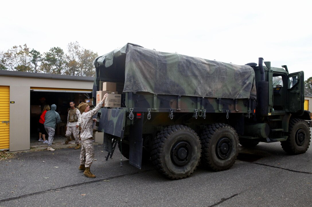 Marines unload a 7-ton truck stocked with disaster relief materials purchased and donated by Kirstie Alley, an actress known for her role in the TV show Cheers, to a post Hurricane distribution site in Toms River N.J., Nov. 3, 2012. Following Hurricane Sandy, Marines from 6th Motor Transport Battalion, 4th Marine Logistics Group, utilized their 7-ton trucks to move donated relief supplies to distribution points amongst the most heavily affected areas. (U.S. Marine Corps photo by Staff Sgt. Nate Hauser/Released)