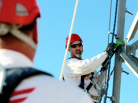 Paul Ratchford, electronics technician and instructor, shows students proper climbing techniques when scaling a communication tower. The students were training to properly climb and rappel off the towers to conduct repairs and keep information flowing.