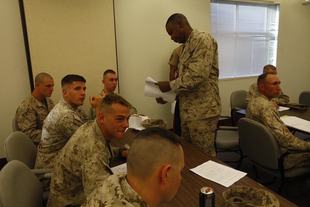 Master Sgt. Roderick T. Harris, a Marine Forces Reserve Career Planner passes out screening forms to change occupations to the Marines of Company D, Anti-Terrorism Battalion, 4th Marine Division, in Billings, Mont., October 20, 2012.  Company D, an infantry company is being transformed into a military police company and Harris was there as part of a Personnel Transition Team, assembled to help Marines make informed career choices as to how they can continue to serve in the Corps.  The move is due to the commandant-directed Force Structure Review, which will affect 147 of 183 Marine Forces Reserve sites as the force restructures and modernizes its units.
