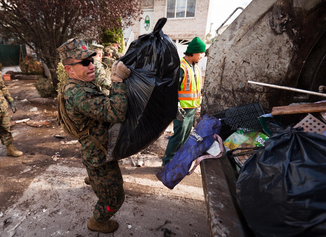 Marines with the 26th Marine Expeditionary Unit pick up trash in the streets of Staten Island, N.Y., Nov. 5. The 26th MEU is able to provide generators, fuel, clean water, and helicopter lift capabilities to aid in disaster relief efforts. The 26th MEU is currently conducting pre-deployment training, preparing for their departure in 2013. As an expeditionary crisis response force operating from the sea, the MEU is a Marine Air-Ground Task Force capable of conducting amphibious operations, crisis response, and limited contingency operations.