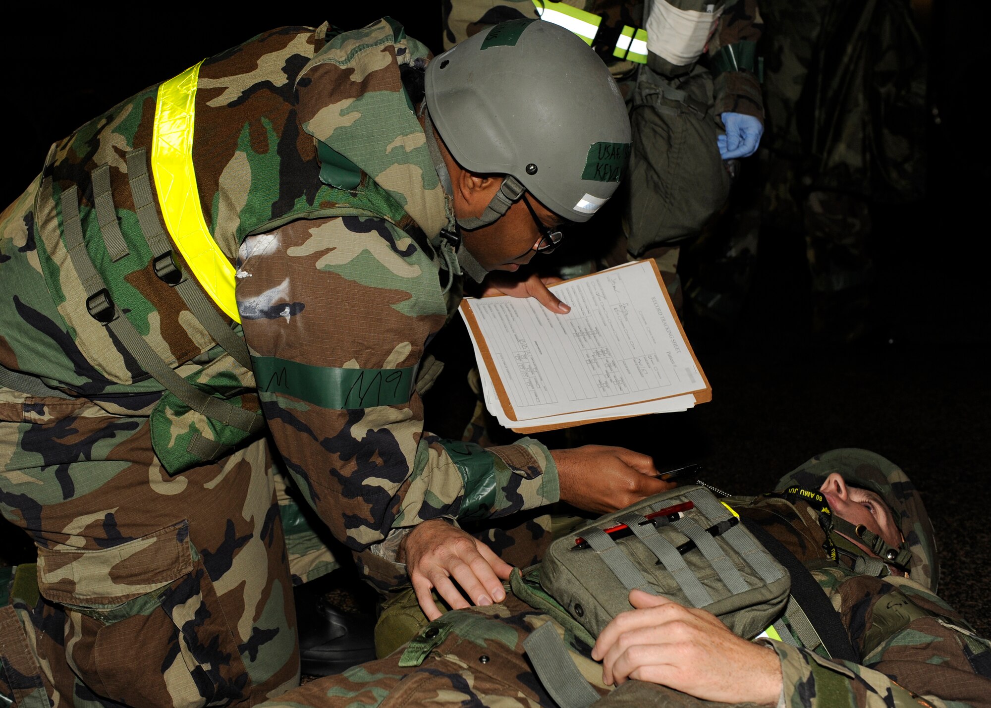 Staff Sgt. Kevin Redus, 8th Medical Operations Squadron verifies the medical records and dog tags of Master Sgt. Joshua Franzen, 8th Aircraft Maintenance Squadron  match during exercise Beverly Bulldog 13-1 on Kunsan Air Base, Republic of Korea, Nov. 6, 2012. Accountability is vital during exercise and real-world scenarios. (U.S. Air Force photo/Senior Airman Marcus Morris)