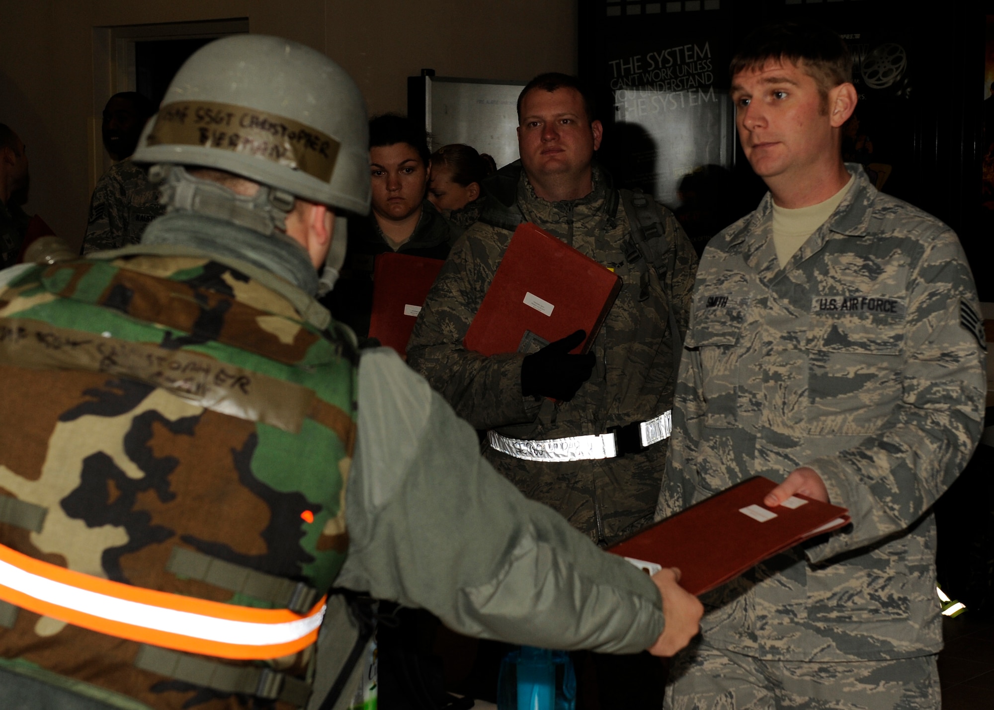 Staff Sgt. Christopher Bierman, 8th Force Support Squadron in-processes Staff Sgt. Jonathan Smith, 8th Medical Operations Squadron during exercise Beverly Bulldog 13-1 on Kunsan Air Base, Republic of Korea, Nov. 5, 2012. The role players allow the 8th FSS to practice working with inbound personnel while accepting follow-on forces in a simulated wartime scenario. (U.S. Air Force photo/Senior Airman Marcus Morris)