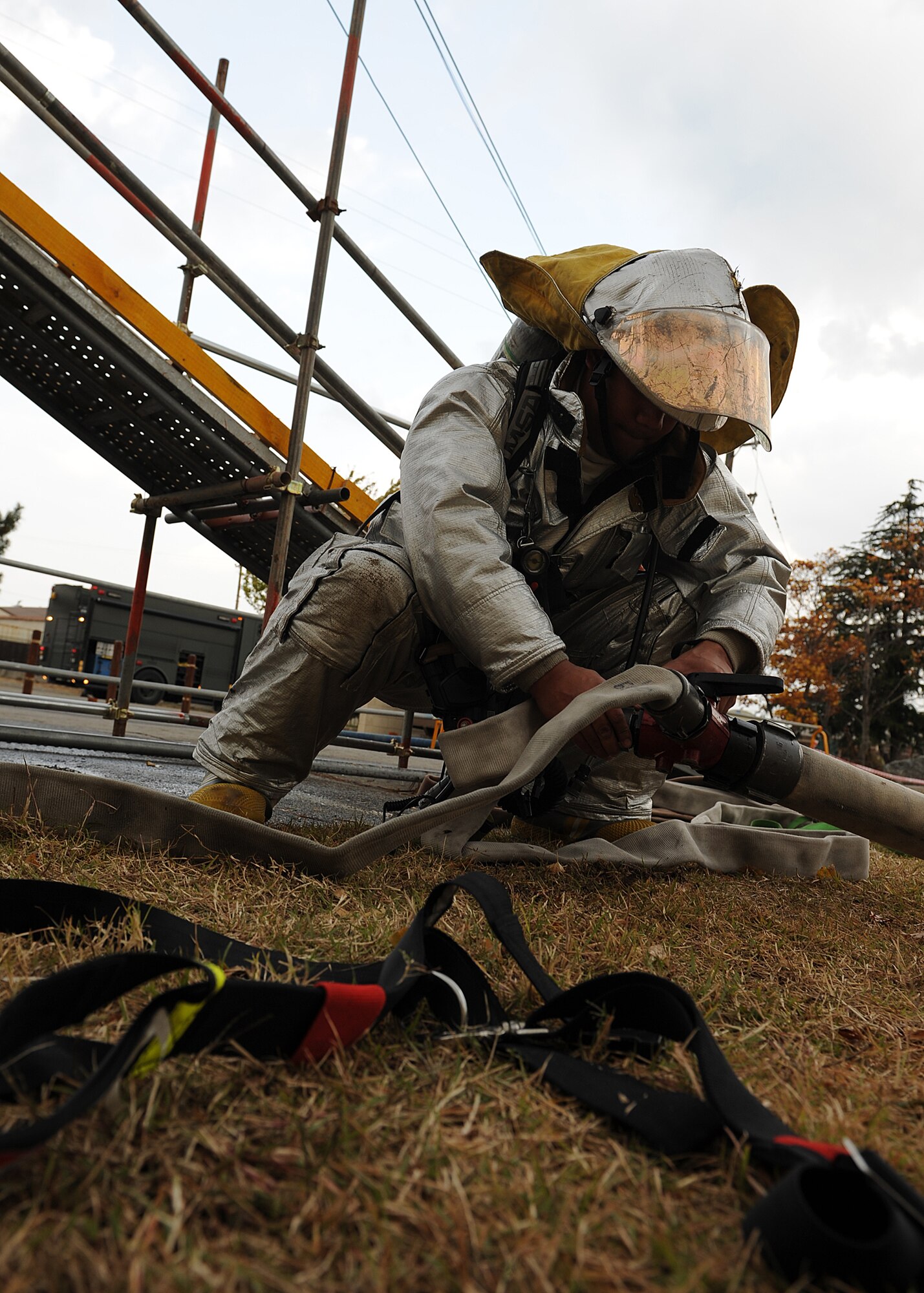 Senior Airman Marlon Brown, 8th Civil Engineer Squadron firefighter, attaches two hoses while responding to a simulated fire during Beverly Bulldog 13-1 on Kunsan Air Base, Republic of Korea, Nov. 5, 2012. The exercise simulates various emergency and wartime scenarios base personnel might be called to respond to. (U.S. Air Force photo/Staff Sgt. Jonathan Fowler)