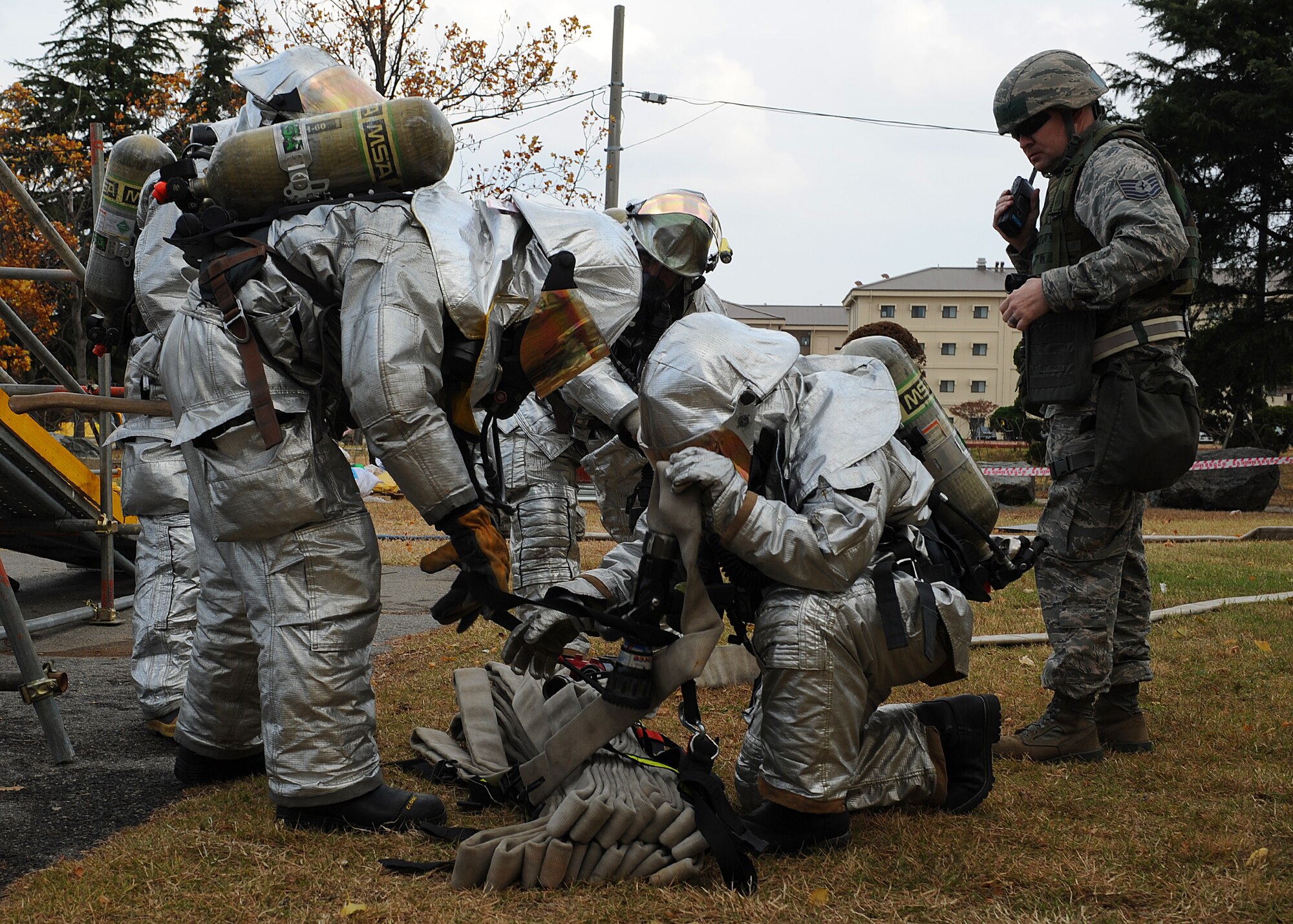 Members of the 8th Civil Engineer Squadron prepare their gear while responding to a simulated fire during Beverly Bulldog 13-1 on Kunsan Air Base, Republic of Korea, Nov. 5, 2012. The exercise simulates various emergency and wartime scenarios base personnel might be called to respond to. (U.S. Air Force photo/Staff Sgt. Jonathan Fowler)