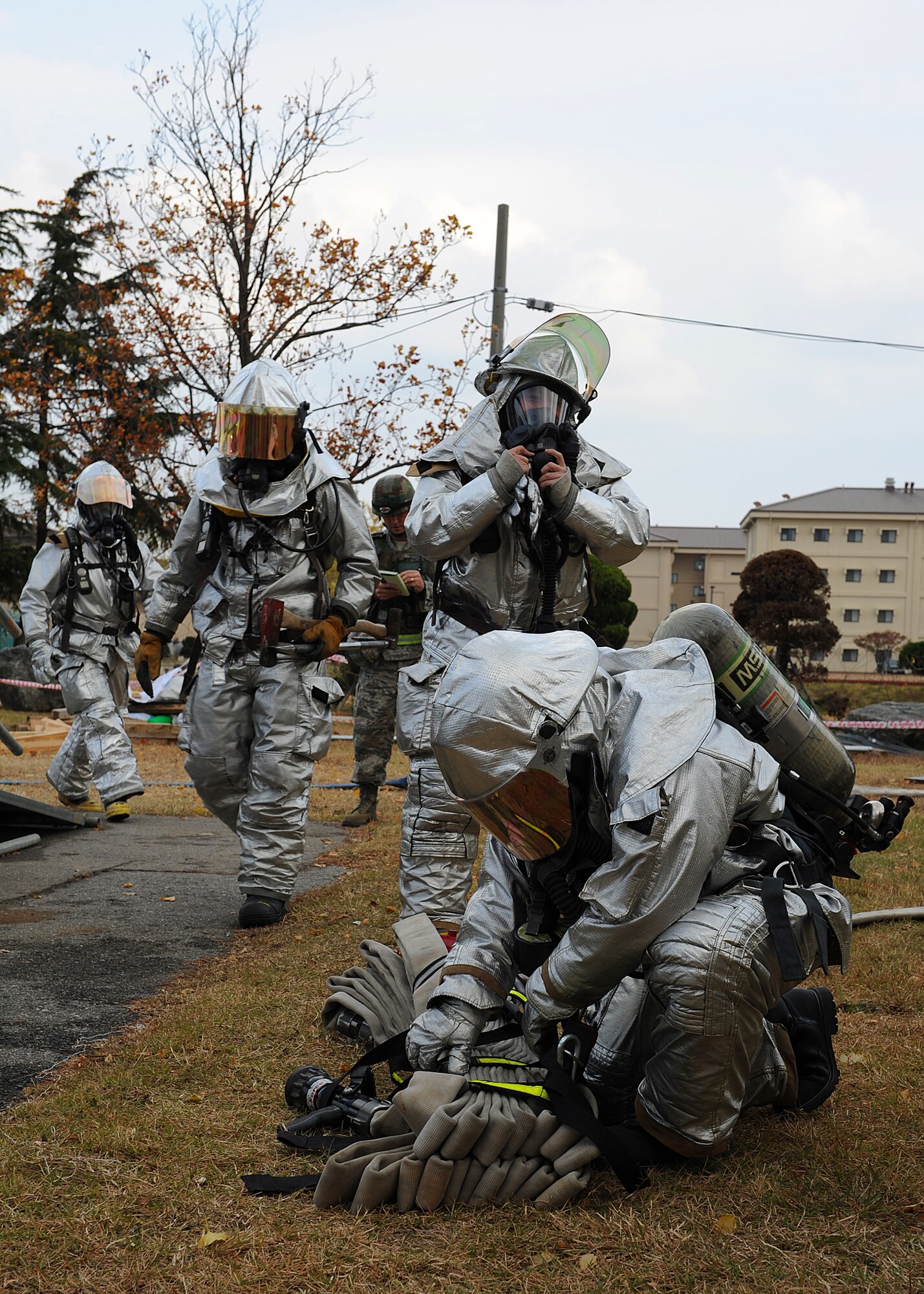 Members of the 8th Civil Engineer Squadron prepare their gear while responding to a simulated fire during Beverly Bulldog 13-1 on Kunsan Air Base, Republic of Korea, Nov. 5, 2012. The exercise simulates various emergency and wartime scenarios base personnel might be called respond to. (U.S. Air Force photo/Staff Sgt. Jonathan Fowler)