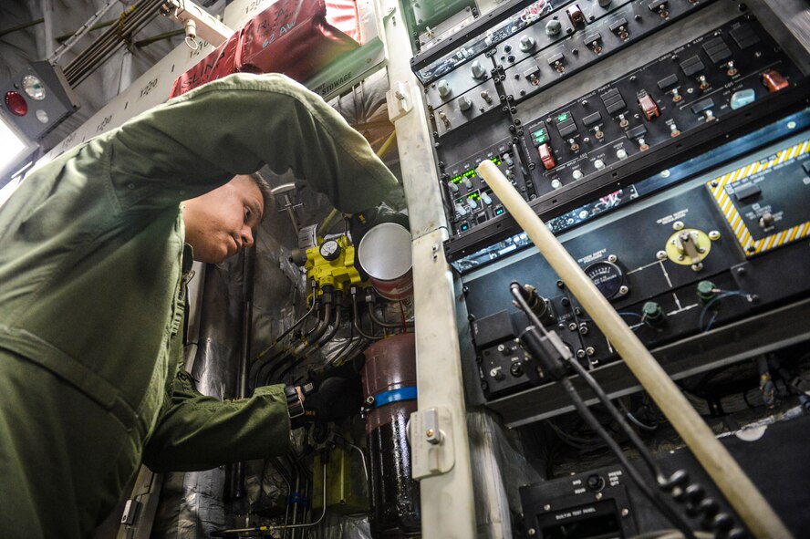 Senior Airman Steven Varner, 8th Airlift Squadron loadmaster, tops off the hydraulic service reservoir on a C-17 Globemaster III aircraft, Nov. 5, 2012, at Joint Base McGuire-Dix-Lakehurst, N.J. After off-loading equipment transported from Joint Base Lewis-McChord, Wash., for Hurricane Sandy relief, the C-17 crew performed minor aircraft servicing and were back in the air an hour and 40 minutes after off loading their equipment and passengers. (U.S. Air Force photo/Staff Sgt. Sean Tobin)