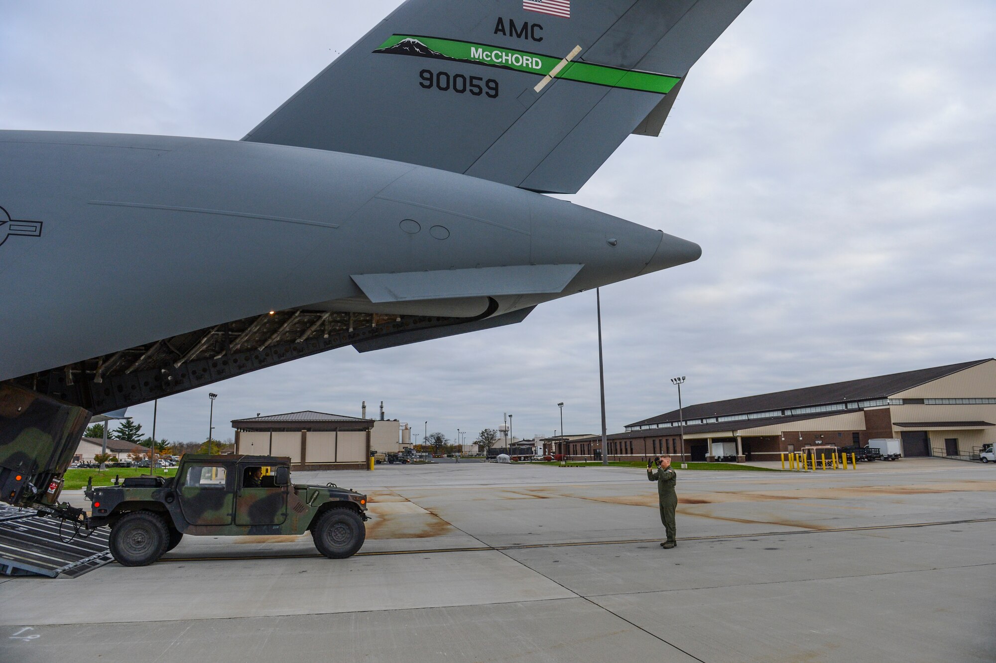 Senior Airman Steven Varner, 8th Airlift Sqadron loadmaster, marshalls a humvee off the back of a C-17 Globemaster III aircraft, Nov. 5, 2012, at Joint Base McGuire-Dix-Lakehurst, N.J. The vehicle was sent along with other equipment and Army personnel from Joint Base Lewis-McChord, Wash., to help inspect air and water samples for safety. (U.S. Air Force photo/Staff Sgt Sean Tobin)