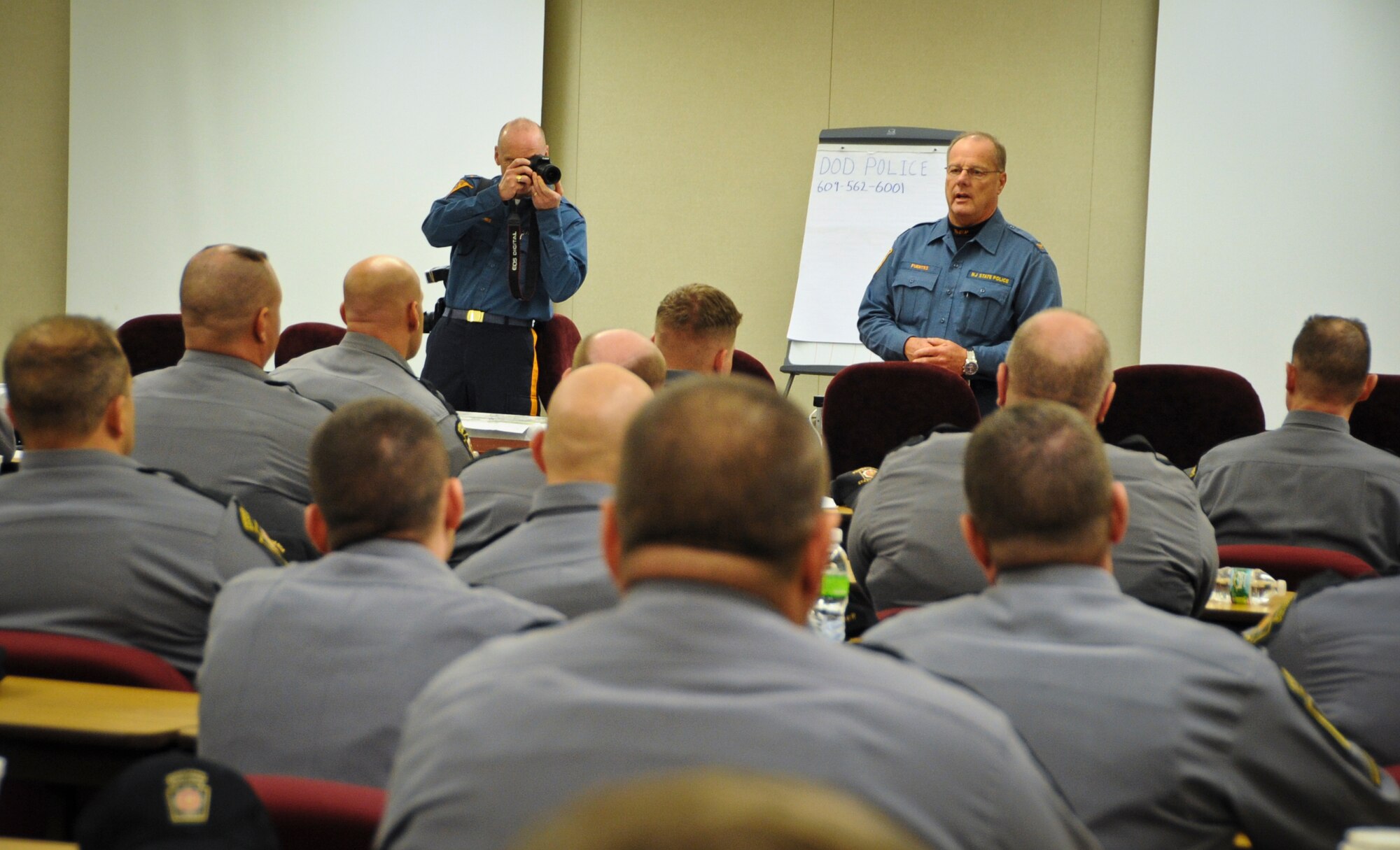JOINT BASE MCGUIRE-DIX-LAKEHURST, N.J. -- New Jersey State Police Col. Joesph Fuentes, NJSP superintendent, speaks to state police officers at the Joint Training and Training Development Center at Joint Base McGuire-Dix-Lakehurst, N.J., Nov. 5, 2012. Fuentes and the New Jersey attorney general flew by helicopter to the base to hold a mass swear-in ceremony for more than 250 state police officers from eight states. Troopers drove police vehicles and motorcycles from as far as Louisiana to support the NJSP in the wake of Hurricane Sandy. (U.S. Air Force photo by Staff Sgt. David Carbajal/Released)