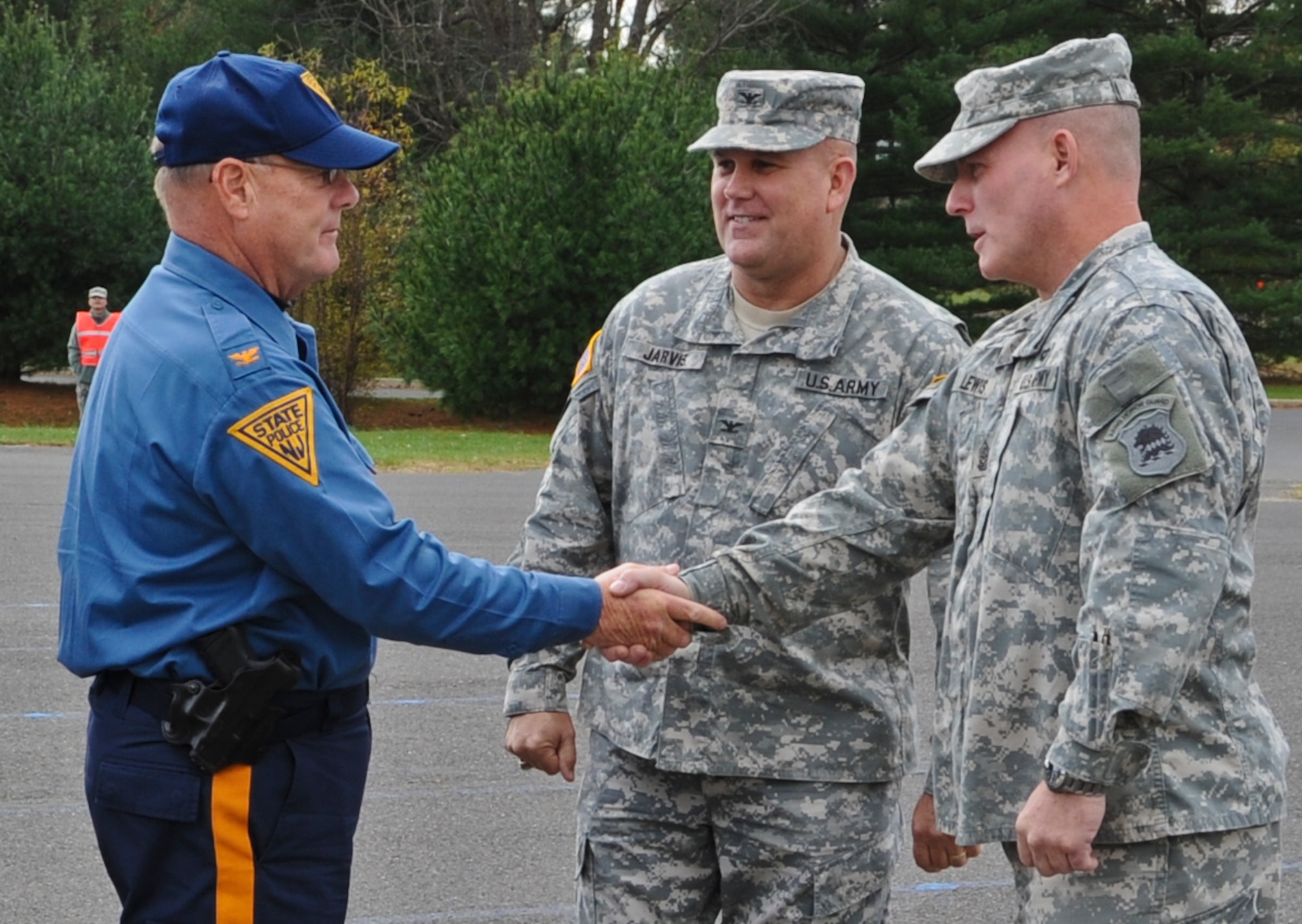 JOINT BASE MCGUIRE-DIX-LAKEHURST, N.J. -- Command Sgt. Maj. Kevin Lewis, Joint Training and Training Development Center (JT2DC) superintendent, greets New Jersey State Police Col. Joesph Fuentes, NJSP superintendent, shortly after the colonel arrived by helicopter to the JT2DC at the Joint Training and Training Development Center at Joint Base McGuire-Dix-Lakehurst, N.J., Nov. 5, 2012. Fuentes and the New Jersey attorney general flew by helicopter to the base to hold a mass swear-in ceremony for more than 250 state police officers from eight states. Troopers drove police vehicles and motorcycles from as far as Louisiana to support the NJSP in the wake of Hurricane Sandy. (U.S. Air Force photo by Staff Sgt. David Carbajal/Released)