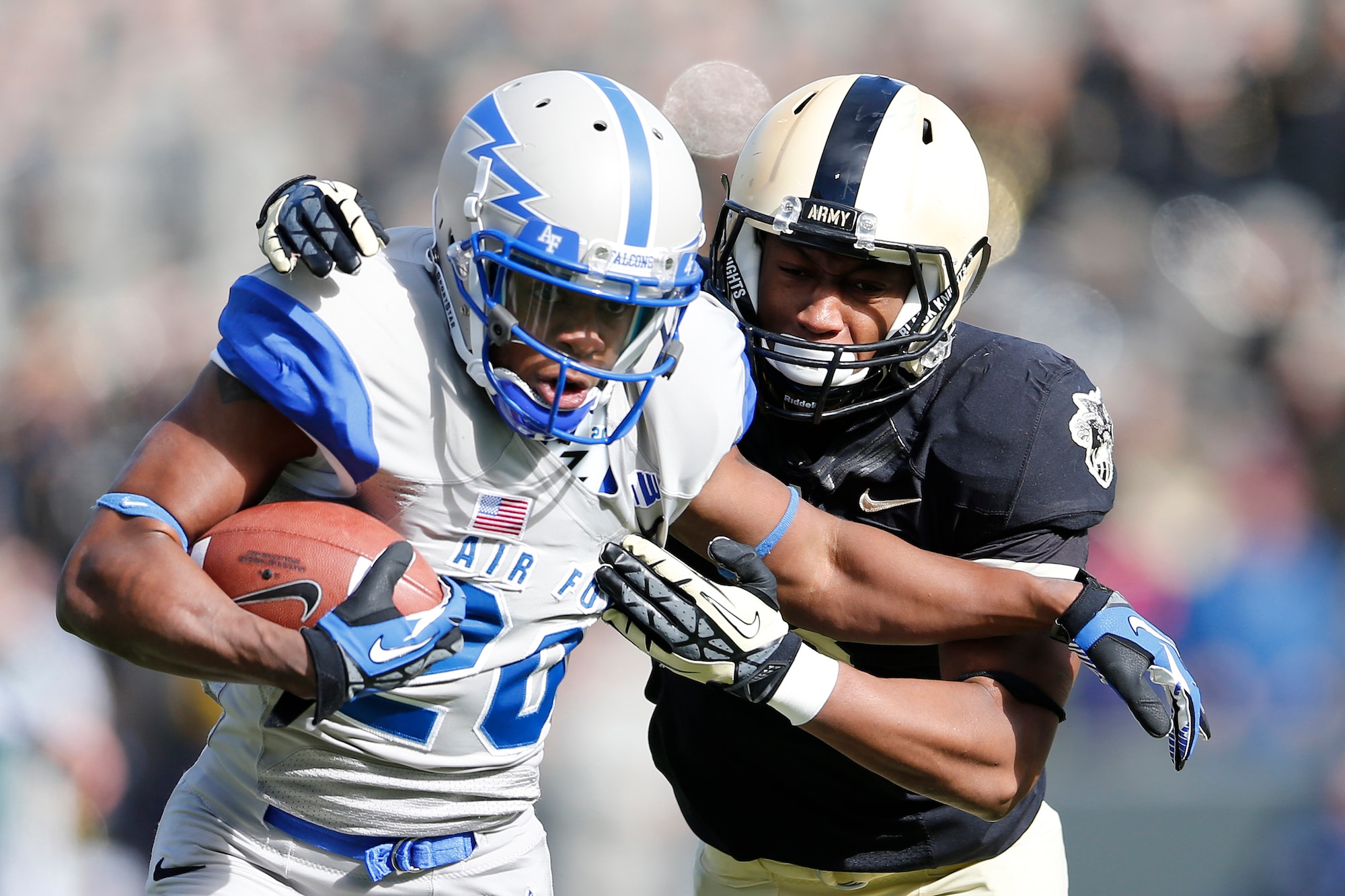 Air Force wide receiver Dontae Strickland tries to break away from Army defensive back Chris Carnegie after catching a pass during the NCAA Football game between Falcons and Black Knights at Michie Stadium in West Point, N.Y., Nov. 3. Army defeated Air Force 41-21, earning their first victory over Air Force since 2005. (U.S. Army photo/Tommy Gilligan)