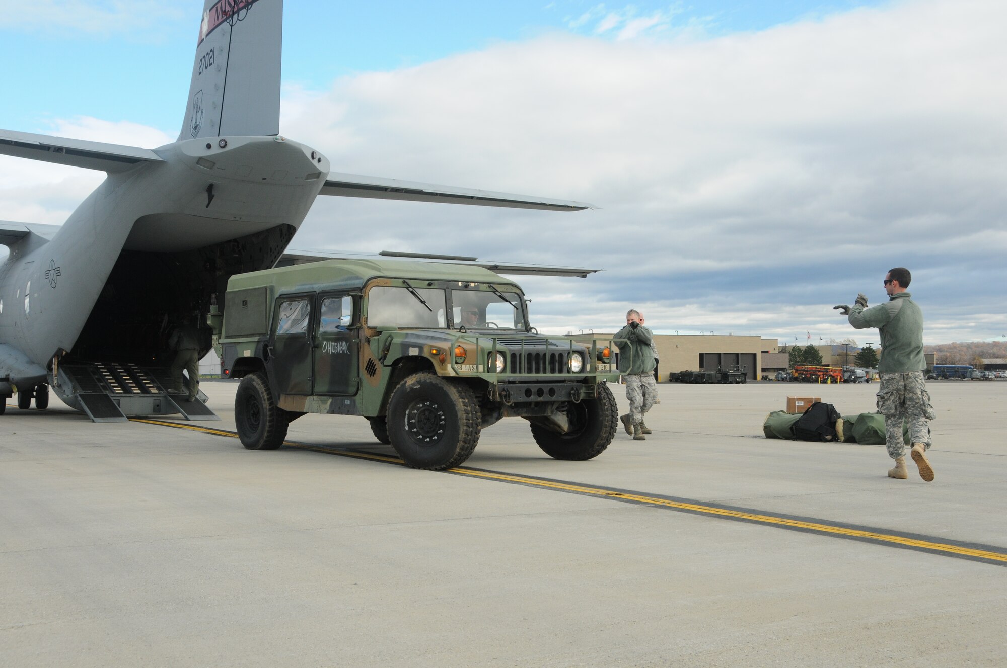 A U. S. Army Humvee from the Ohio National Guard is unloaded from a Mississippi Air National Guard C-27J Spartan military transport aircraft on Stewart Air National Guard Base, Newburgh, NY, Nov. 3, 2012. The Humvee will be used to support the relief efforts of the New York National Guard in Brooklyn, NY, for the victims of Hurricane Sandy. (U. S. Air Force Photo by Tech. Sgt. Richard L. Smith/Released)