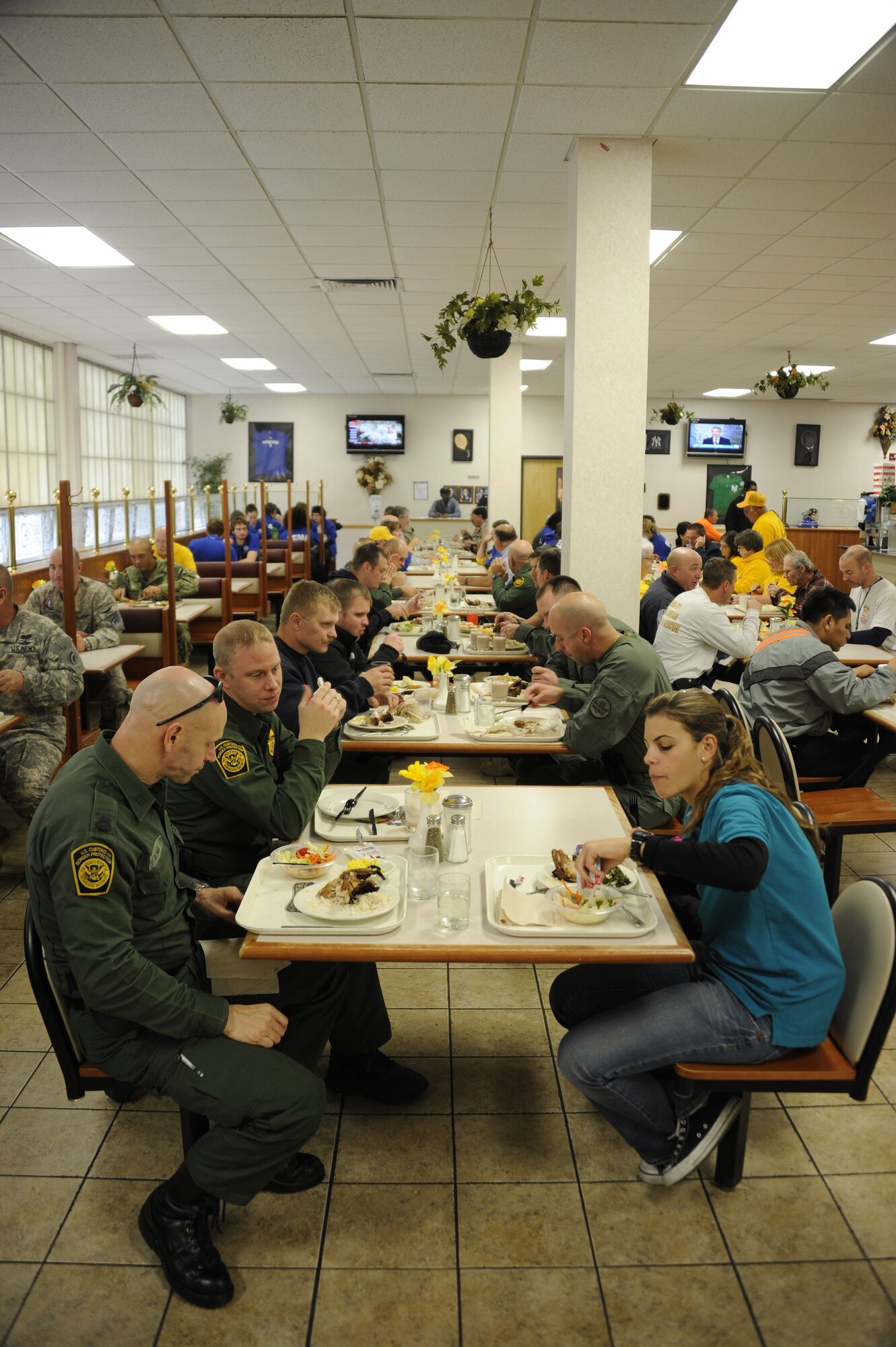 Federal Emergency Management Agency contractors, Department of Defense employees and other federal employees enjoy a quick meal Nov. 4, 2012, at a Dix dining facility.The Reception Control Center along with the 167th Theater Support Command, are collaborating to track, care for and sustain all incoming federal, state and local hurricane relief assets currently on Joint Base McGuire-Dix-Lakehurst. (U.S. Air Force photo by Airman 1st Class Ryan Throneberry/Released)