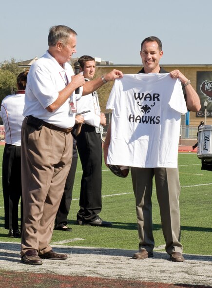 U.S. Air Force Col. Vincent Lostetter, 7th Bomb Wing vice commander, accepts a McMurry University t-shirt during Military Appreciation Day Nov. 3, 2012, in Abilene, Texas. Military members and their families were honored with free food, a tailgate party and free entry to the McMurry University versus Texas College football game. (U.S. Air Force photo by Airman 1st Class Jonathan Stefanko/ Released)