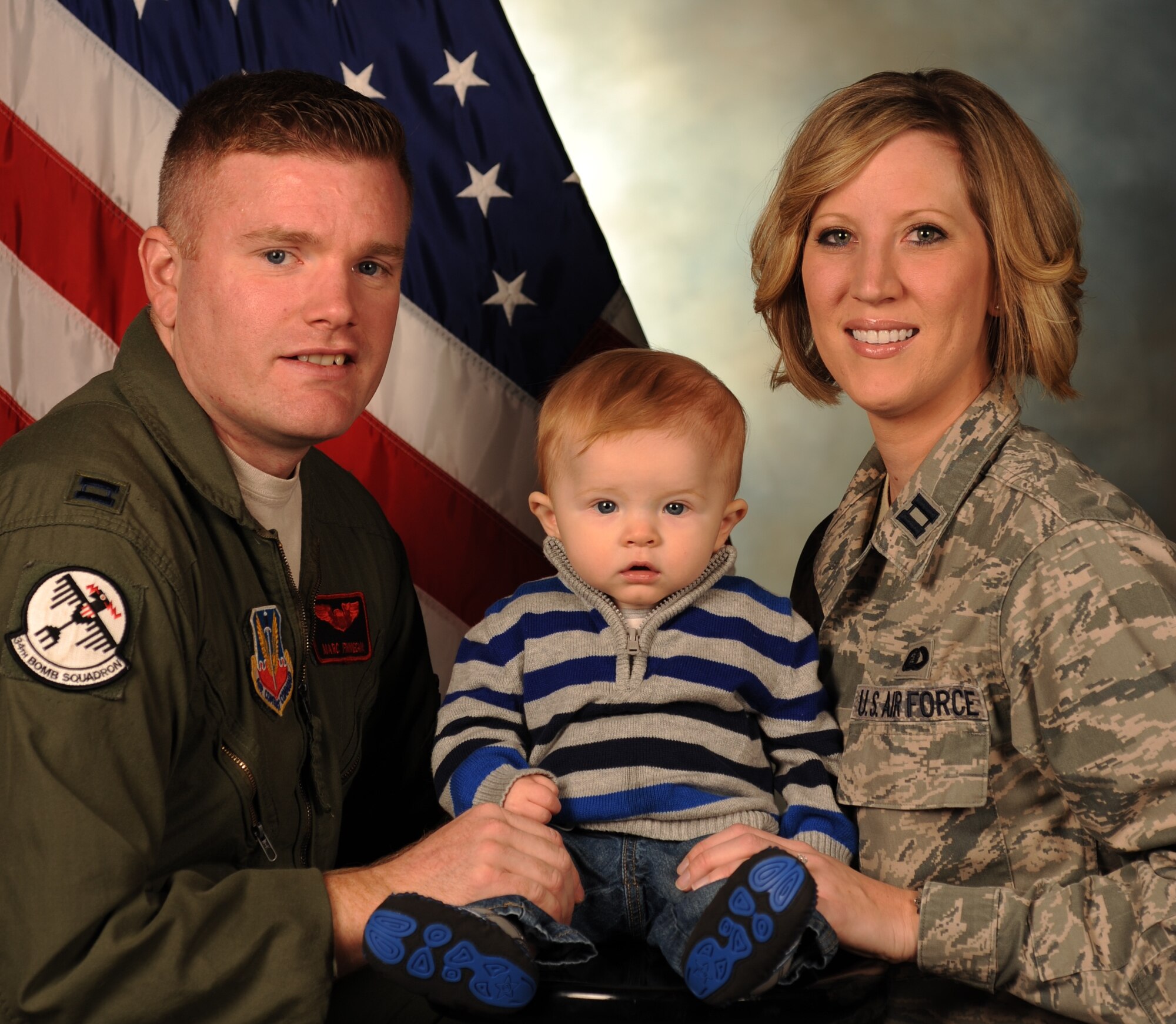 Capts. Marc Finnegan, 34th Bomb Squadron B-1 pilot, and his wife Amanda Finnegan, 28th Mission Support Group executive officer, are a dual military couple and parents to their 8-month-old son, Zachary, at Ellsworth Air Force Base, S.D. Family Care Plans are required for mil-to-mil couples with dependents to ensure their family is cared for during any simultaneous dependent-restricted missions including deployments, temporary duty assignments, and select permanent changes of station. (U.S. Air Force photo by Airman 1st Class Audra M. Hornbacher/Released)